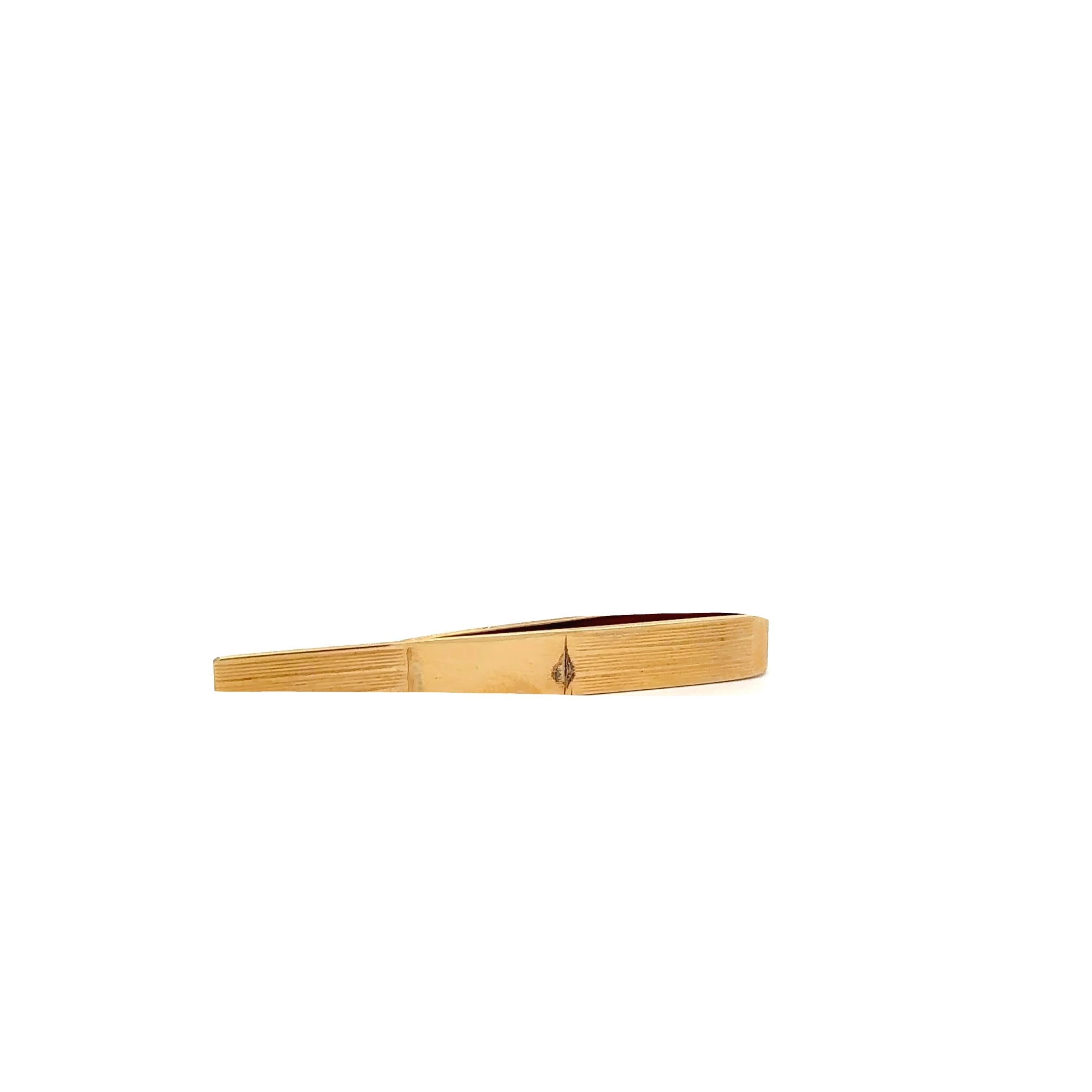 Una spilla da cravatta minimalista realizzata in oro giallo 14k. Il design è caratterizzato da linee pulite e da una finitura liscia che incarna la semplicità e l'eleganza. Questo pezzo riflette un'influenza vittoriana, mostrando un'artigianalità