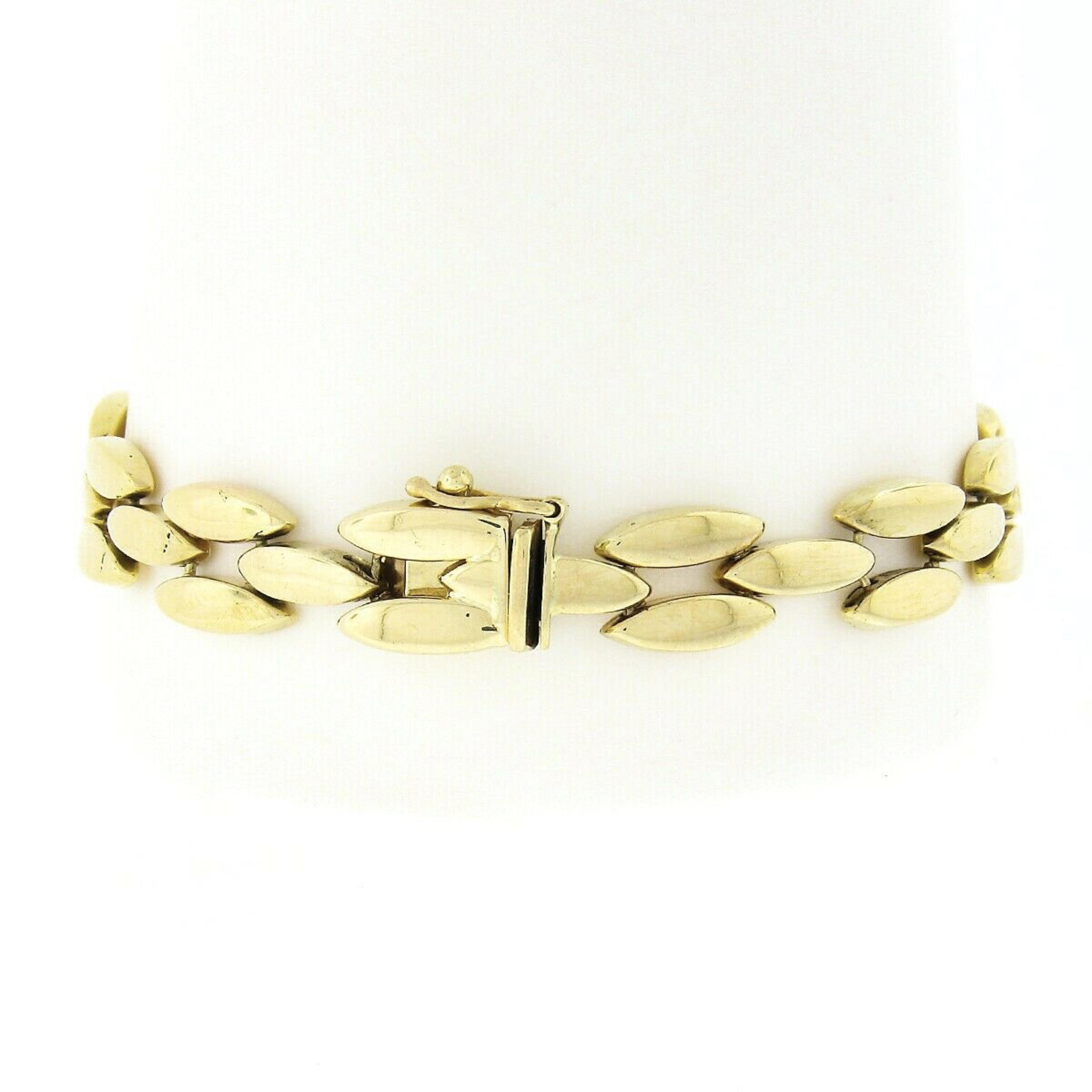 You are looking at an absolutely gorgeous Tiffany & Co. bracelet crafted in solid 14k yellow gold. The bracelet measures approximately 10mm wide and features three rows of panther links that have a nice high-polished finish throughout granting an a