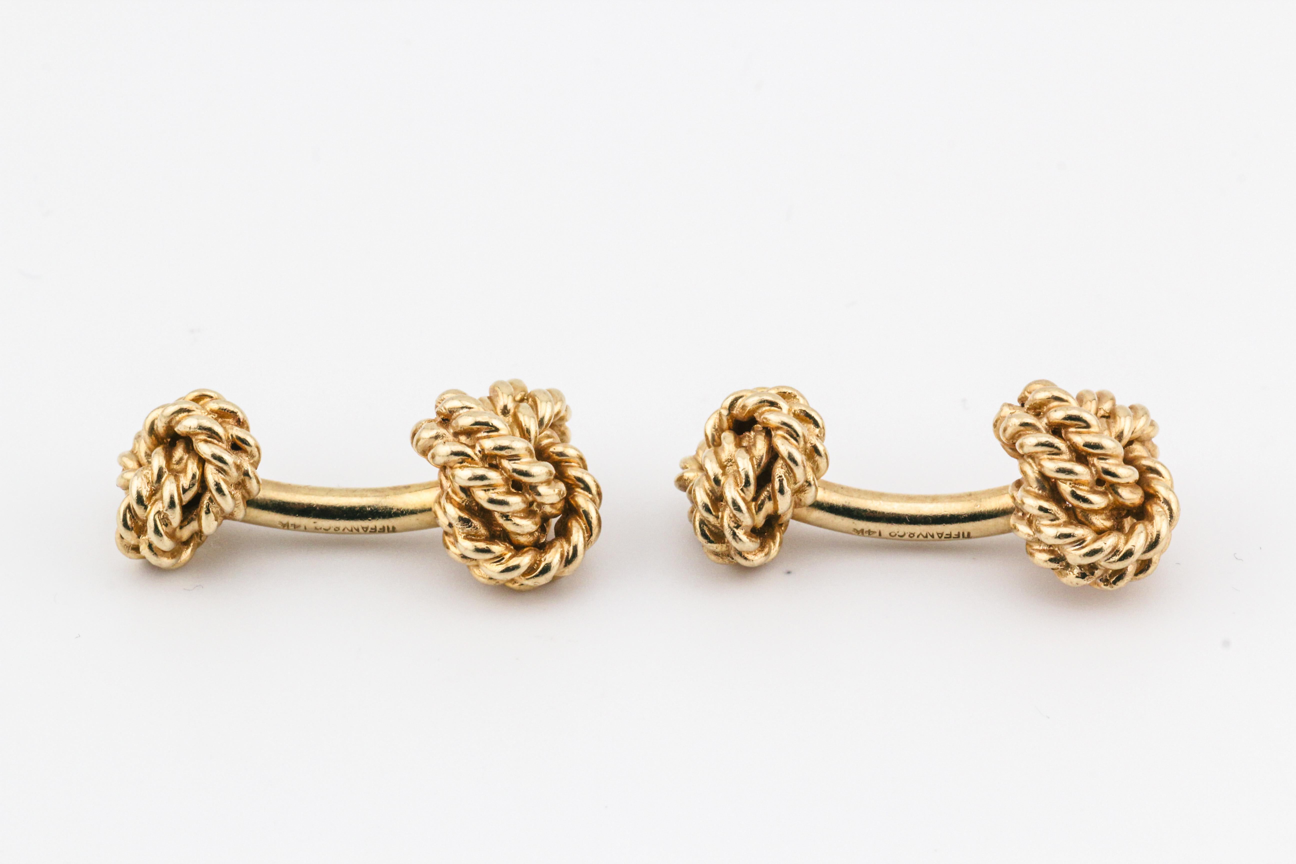 Introducing the Tiffany & Co. 14k Yellow Gold Rope Knot Cufflinks, a symbol of timeless sophistication and understated elegance. Crafted by the renowned luxury brand Tiffany & Co., these cufflinks are a testament to the brand's legacy of quality