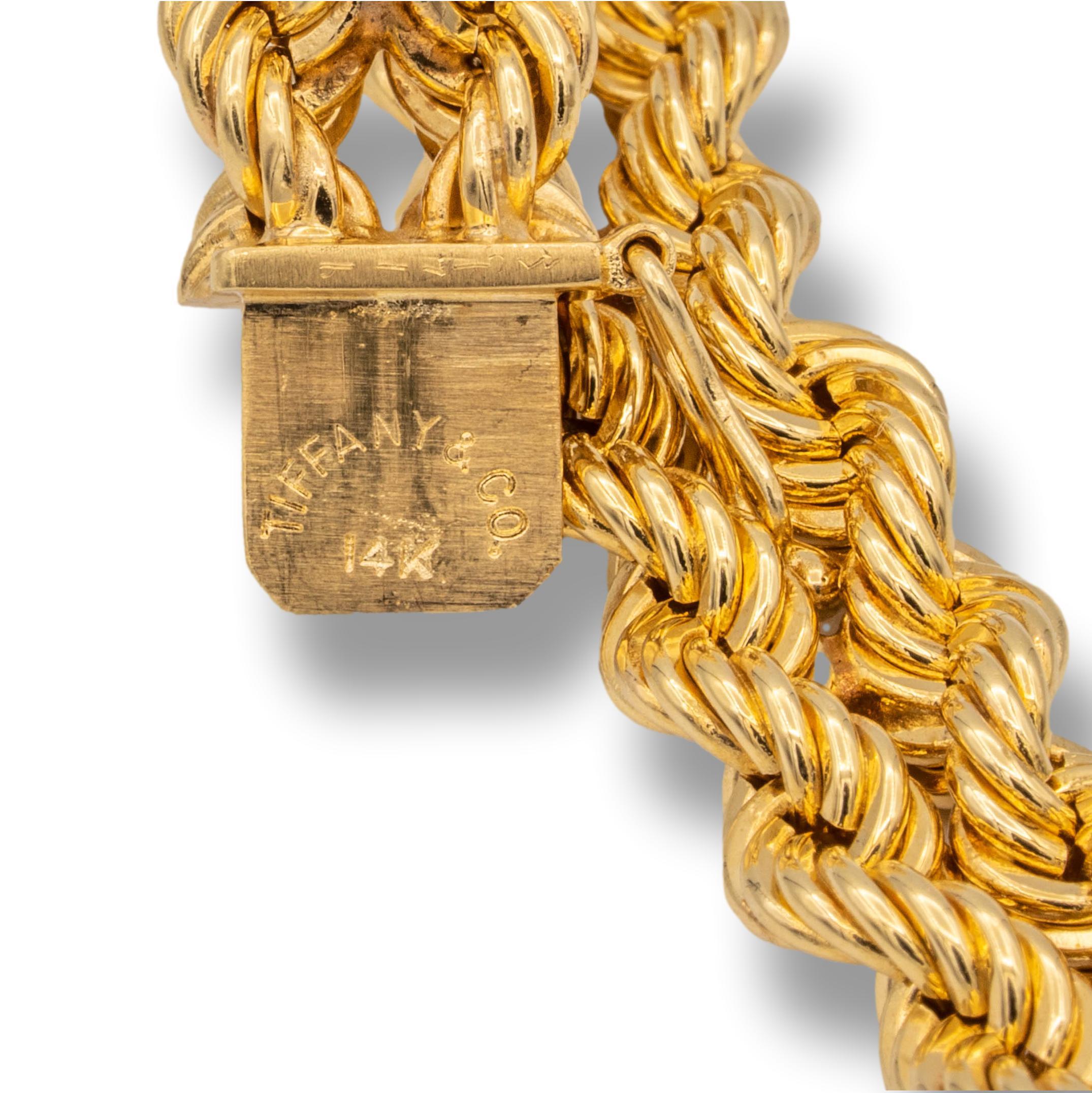 Tiffany & Co. Vintage bracelet from the 1950's finely crafted in 14 karat yellow gold with two rows of twisted rope strands with a push-down large tongue clasp closure with figure-eight for extra safety. Bracelet measures 7