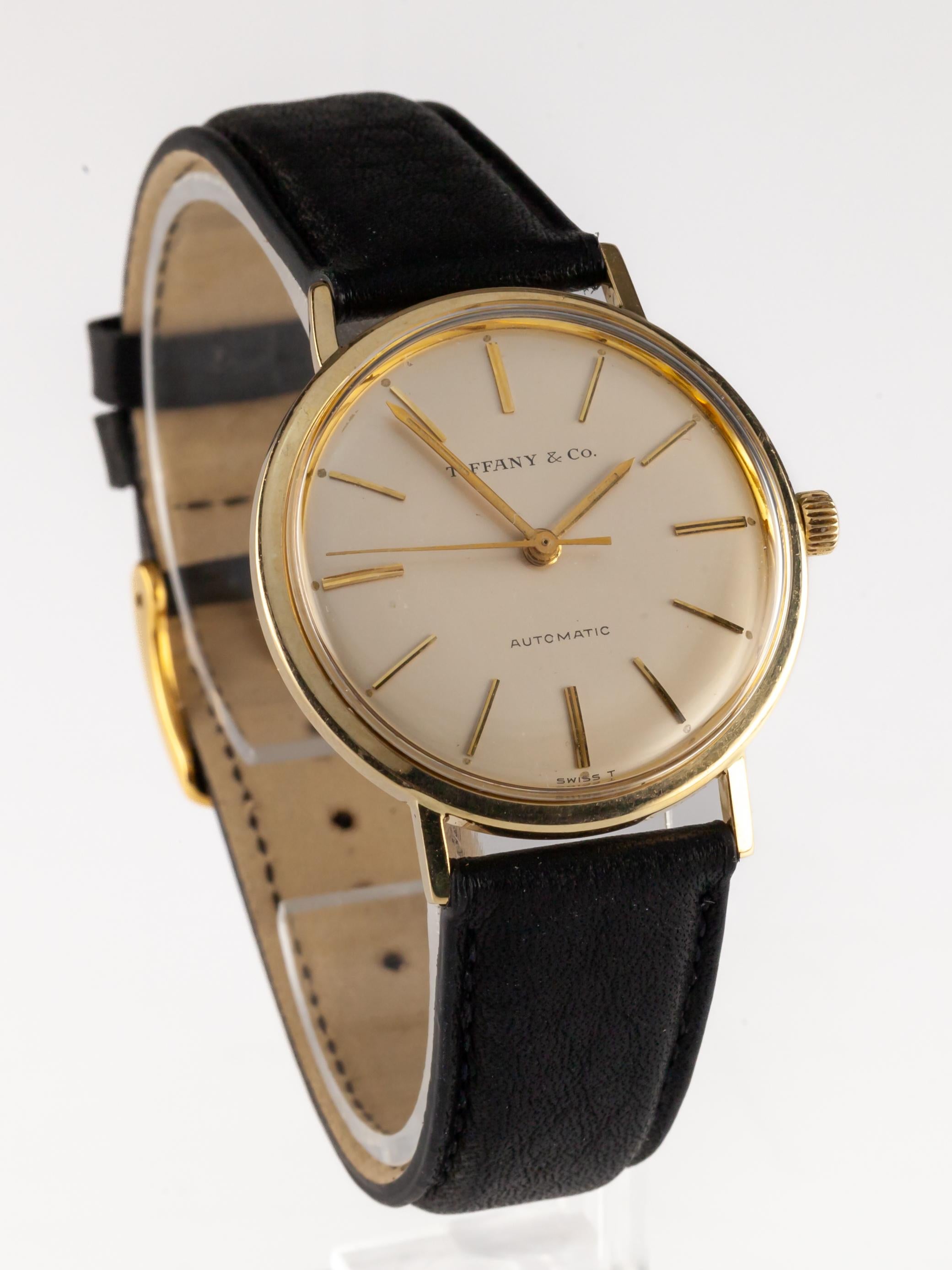 Tiffany & Co. 14k Yellow Gold Vintage Round Men's Automatic Watch Leather Band
Automatic Movement #T.I.B. 554
Case #T-100-5232202

14k Yellow Gold Round Case
34 mm in Diameter (36 mm w/ Crown)
Lug-to-Lug Distance = 39 mm
Lug-to-Lug Width = 18