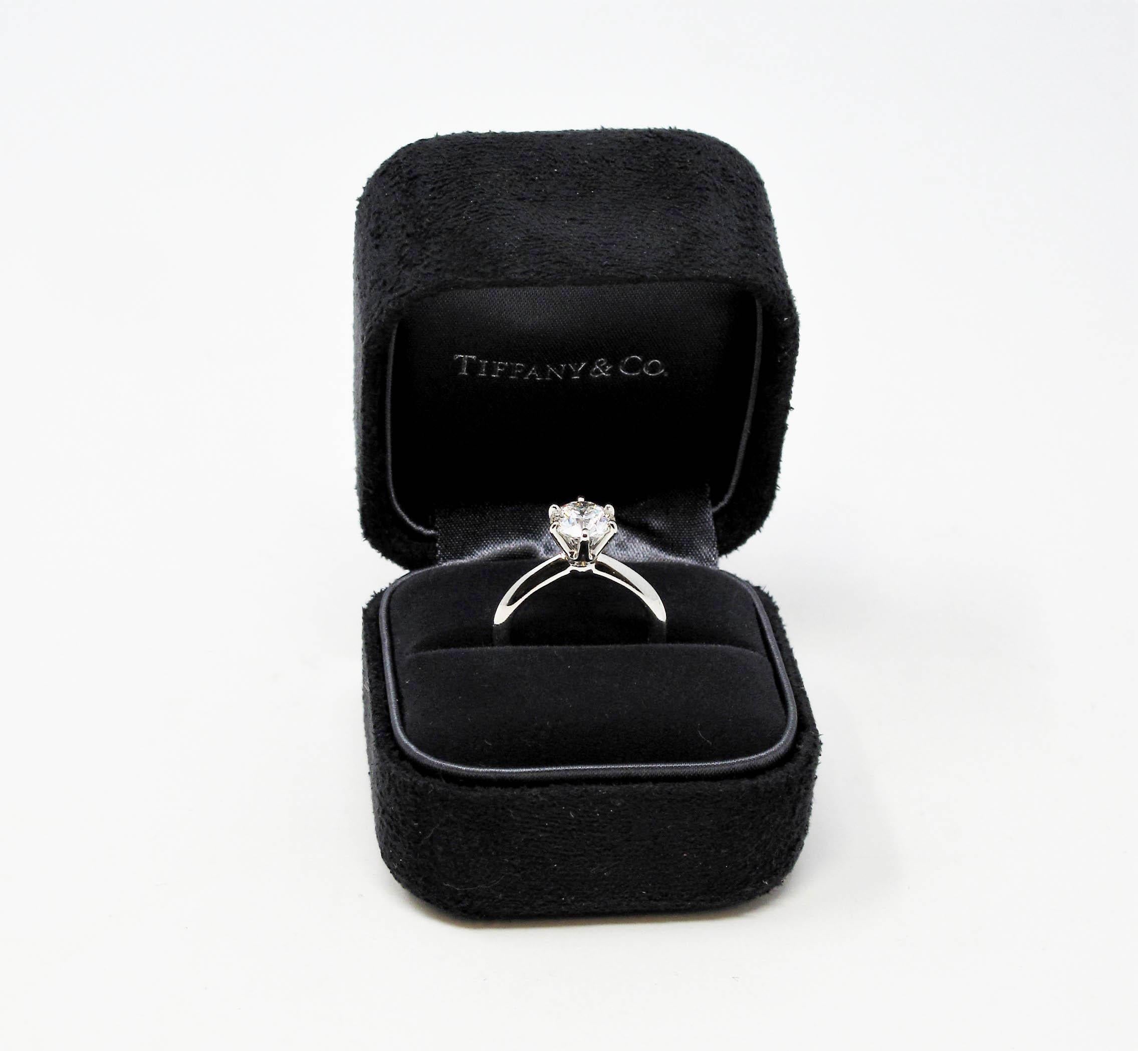 Say yes to this amazing diamond solitaire engagement ring from Tiffany & Co.! This classic, Tiffany style diamond solitaire ring is the epitome of timeless elegance. The round brilliant, bright icy white diamond sparkles radiantly on the finger,