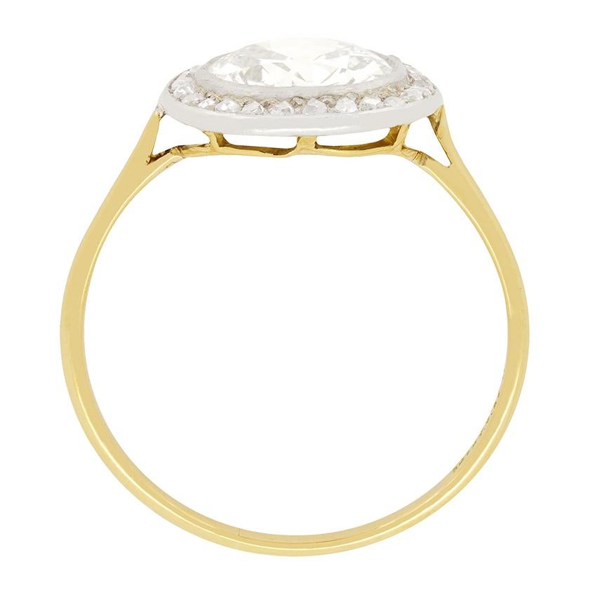 This spectacular ring is a piece of Tiffany & Co.'s history dating back to the 1910s. Prominently sitting in the centre of the piece is a rub over set, 1.55 carat old cut diamond. The diamond is graded I - J in colour and VS1 in clarity. The central