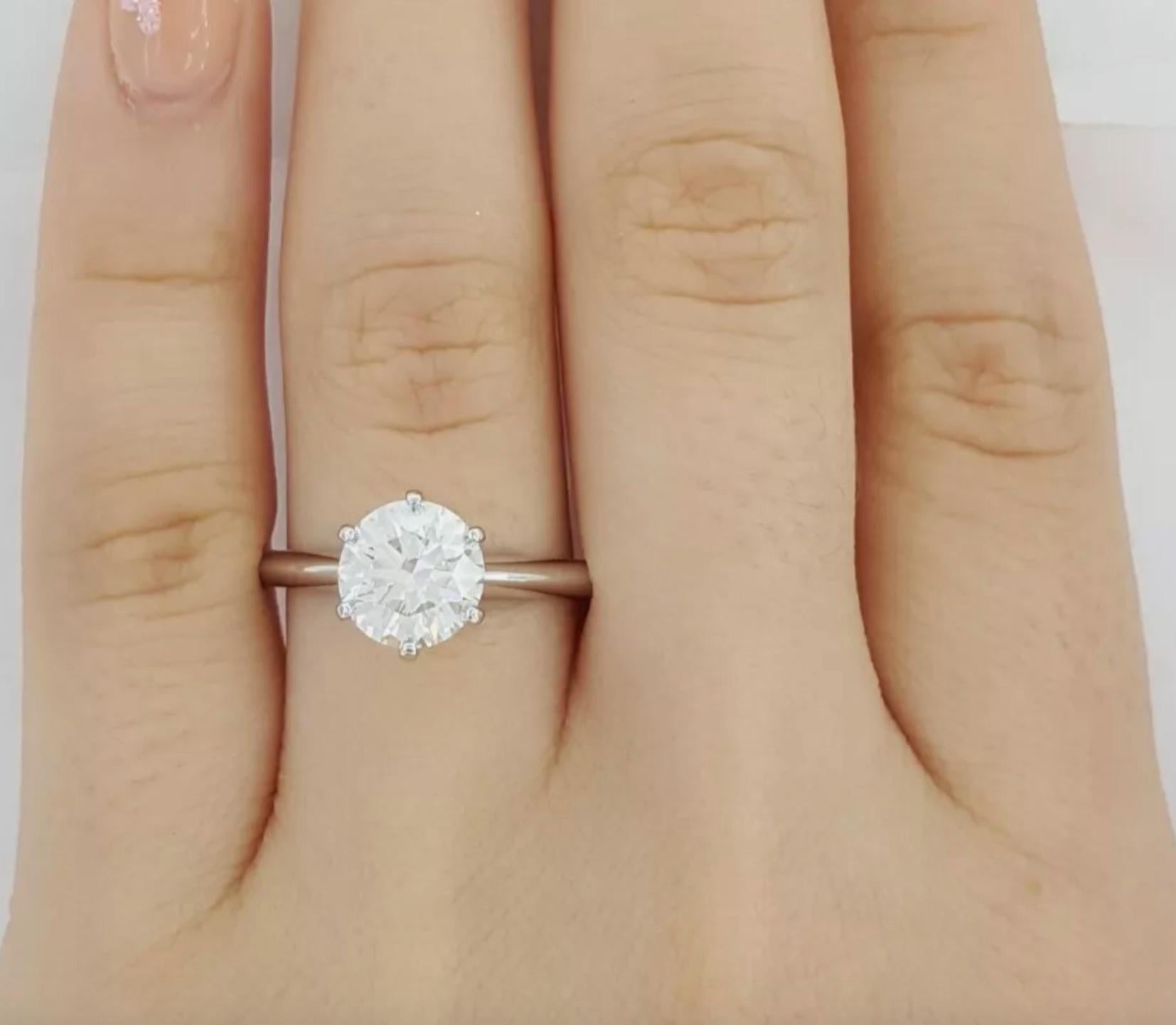 Diamond cut: Round Brilliant 
Carat: 1.59 carats
Color: H
Clarity: VS1
Cut: Excellent
Polish: Excellent
Symmetry: Excellent
Fluorescence: None
Crown Inscription: T&CO.(Serial number)

Metal: Platinum
Ring size: 6.5
Stamp: TIFFANY&CO. Pt950 (Serial