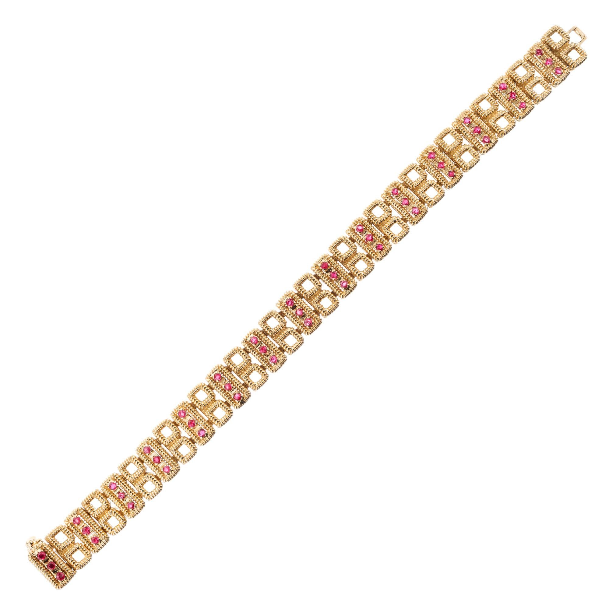 Tiffany & Co. Hinged textured link bracelet. Accented with 45 round rubies in solid 18k yellow gold circa 1980. 6.75 inches. Signed Tiffany & Co Italy 

45 round red rubies, approx. 1.60cts
18k yellow gold 
Stamped: 18k Italy 
Hallmark: Tiffany &