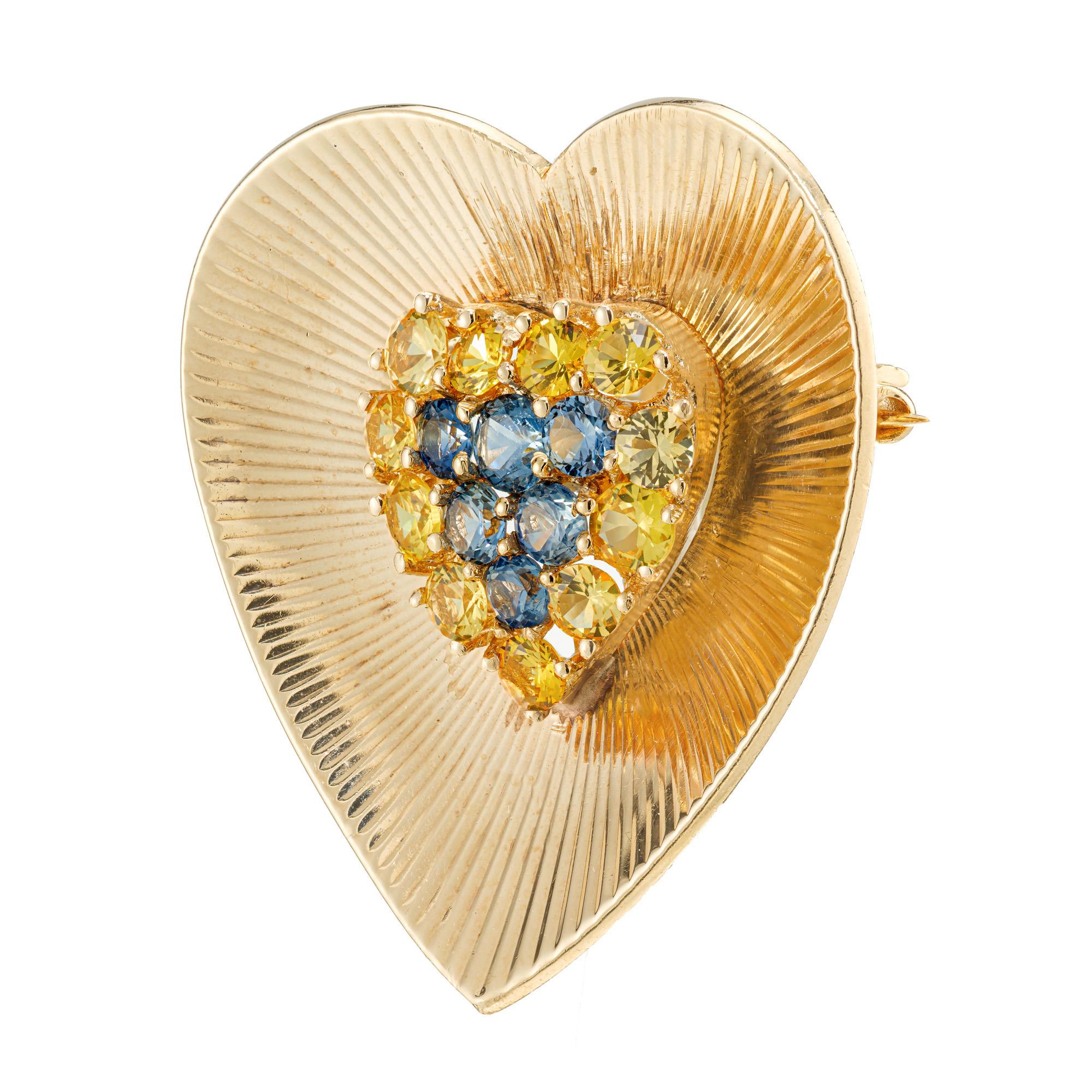Tiffany & Co. 1940's Sapphire brooch. Set with 11 round yellow sapphires and 6 round blue sapphires in fan style heart shaped 14k yellow gold brooch. Classic early century Tiffany. 

11 round genuine yellow Sapphires, approx. total weight 1.00cts
6