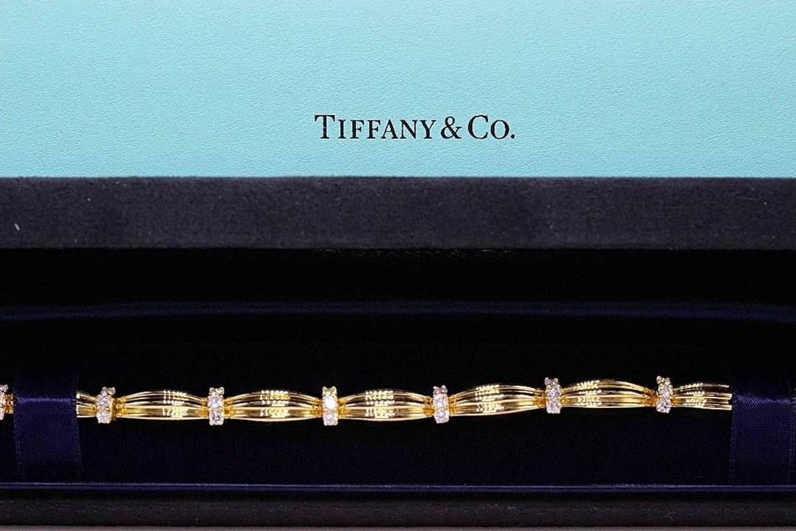 TIFFANY & COMPANY
Style:  1992 Diamond Station Bracelet
Metal:  18KT Yellow Gold - 750
Length:  7 Inches
Total Carat Weight:  1.65 TCW
Diamond Shape:  Round Brilliants Diamonds ( 30 Stones )
Diamond Color & Clarity:  G / VS
Hallmark:  ©1992 T&CO