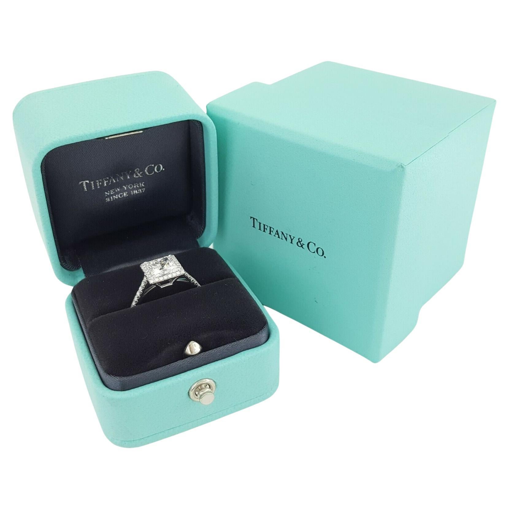 An exquisite Tiffany Soleste engagement ring. 

With a halo of brilliant bead-set diamonds and a stunning princess-cut center stone, light is gathered and mirrored throughout the design, resulting in an unrivaled display of brilliance. 

The center