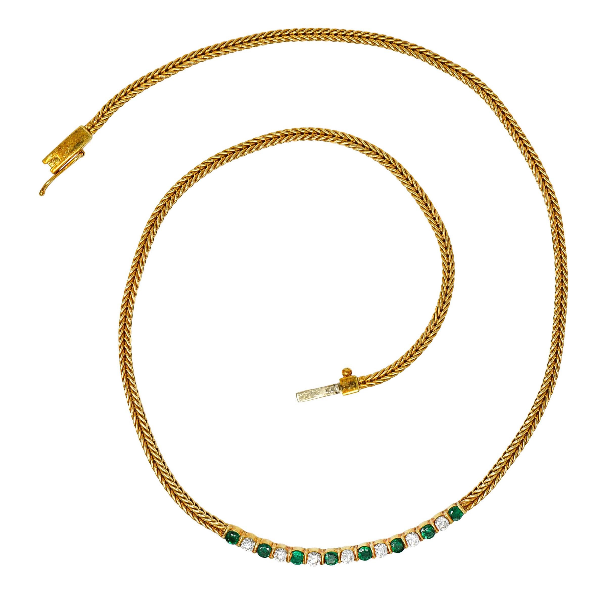 Necklace designed as a finely braided wheat chain necklace

With a central bar station featuring round cut emeralds and round brilliant cut diamonds

Emeralds are a well-matched vivid green in color while weighing approximately 1.00 carat

Diamonds