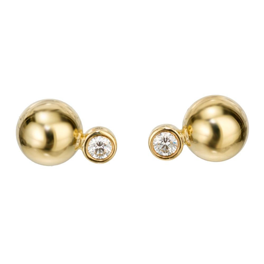 Tiffany & Co 18k yellow gold balls and bezel set diamond stud earrings. 2 round brilliant bezel set diamonds in 18k yellow gold. 

2 round brilliant cut diamonds, G VS approx. .18cts
18k yellow gold 
Stamped: T + Co 750
Hallmark: T + Co
3.2