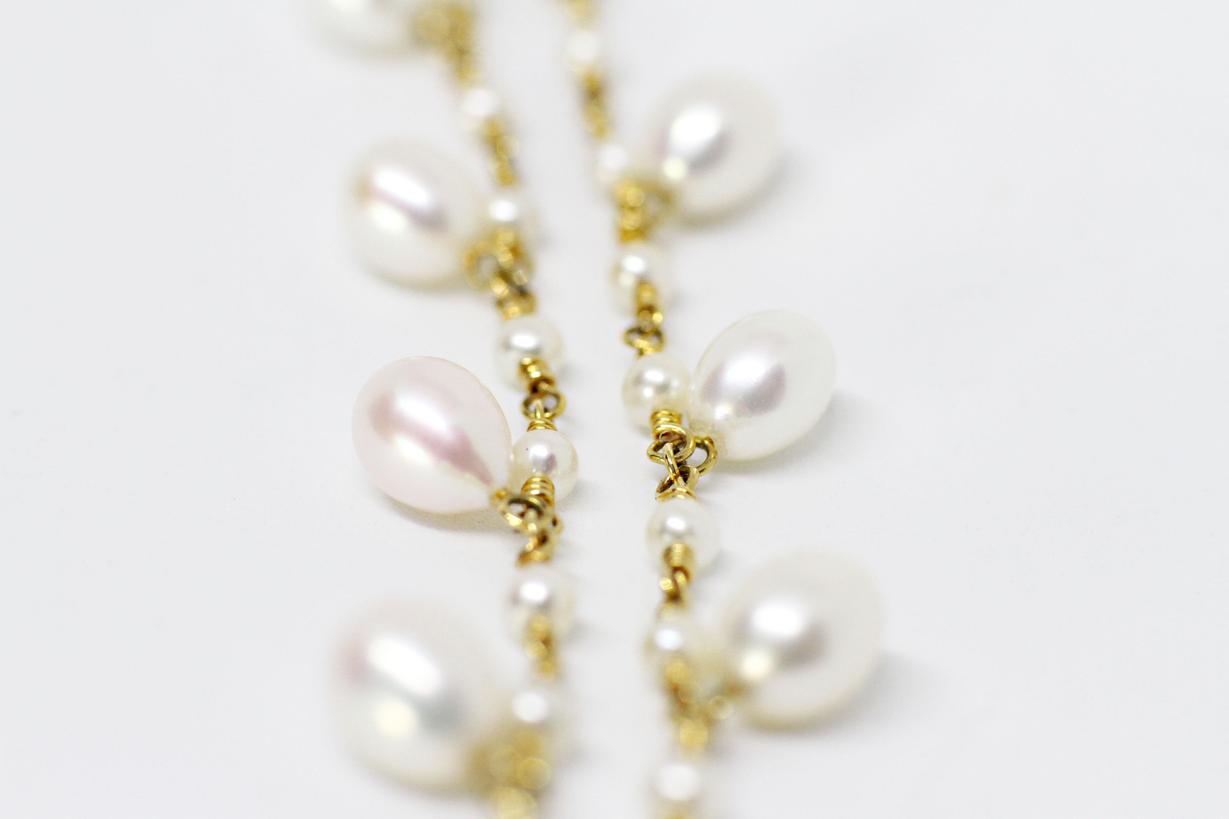 Beautiful Tiffany & Co pearl necklace made with 38 round white pearls averaging 3.5 millimeters each in an open link 18 carat yellow gold knot style chain. In addition, the necklace is accompanied by nine hanging larger tear drop shape fine quality