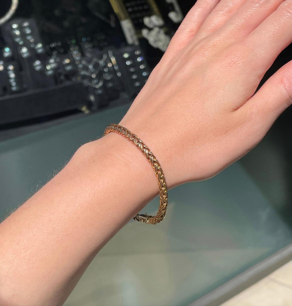 This classic bracelet by Tiffany & Co. showcases a braided round wheat chain design masterfully crafted from 18 carat yellow gold. This piece screams vintage Tiffany, and would look divine with both casual and formalwear. 

The fantastic piece is