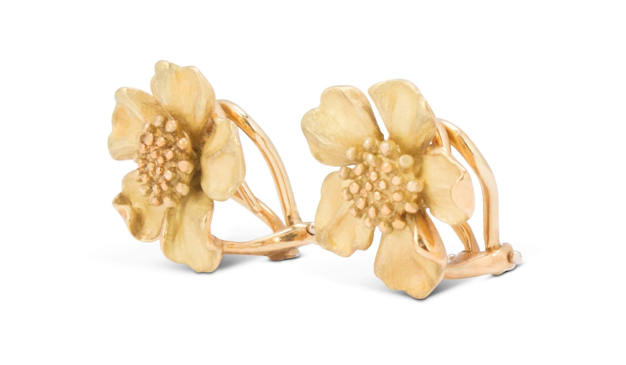 Authentic Tiffany & Co. Dogwood flower earrings crafted in 18 karat yellow gold.  Featuring a charming floral design with delicately up-turned petals, each earring measures 17mm x 17mm.  Signed T&CO, 750.  CIRCA 1990s