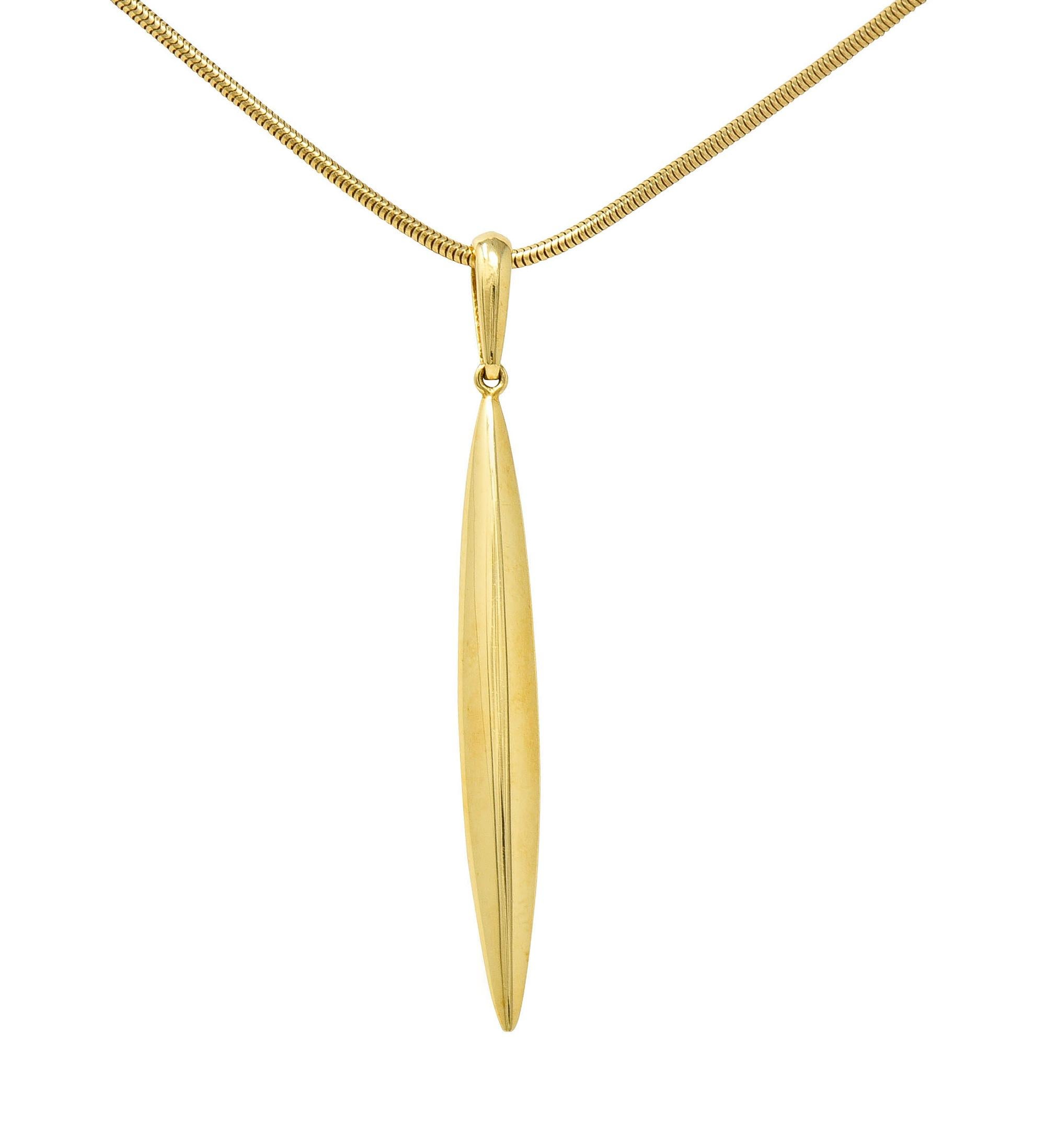18 karat gold snake chain suspends a streamlined pendant featuring a stylized feather

Chain is lightweight and springy while pendant is brightly polished

Completed by logo link and lobster clasp

Both chain and pendant are stamped 750 for 18 karat