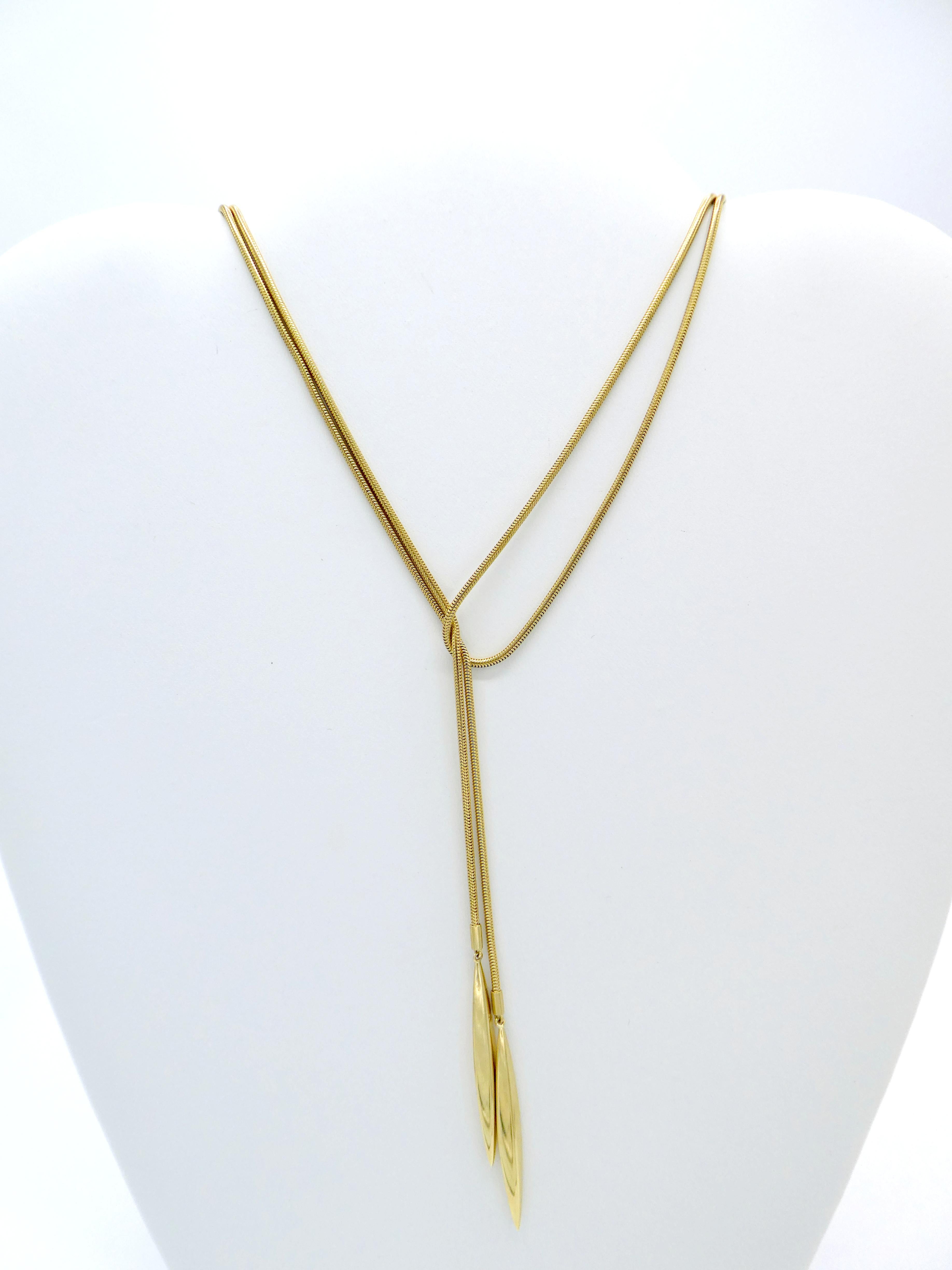 Tiffany & Co. 18 Karat Gold Lariat Double Feather Snake Chain Wrap Necklace

Metal: 18k yellow gold
Weight: 32 grams
Length: 51 inches
Width: 1.57 mm
Markings: 