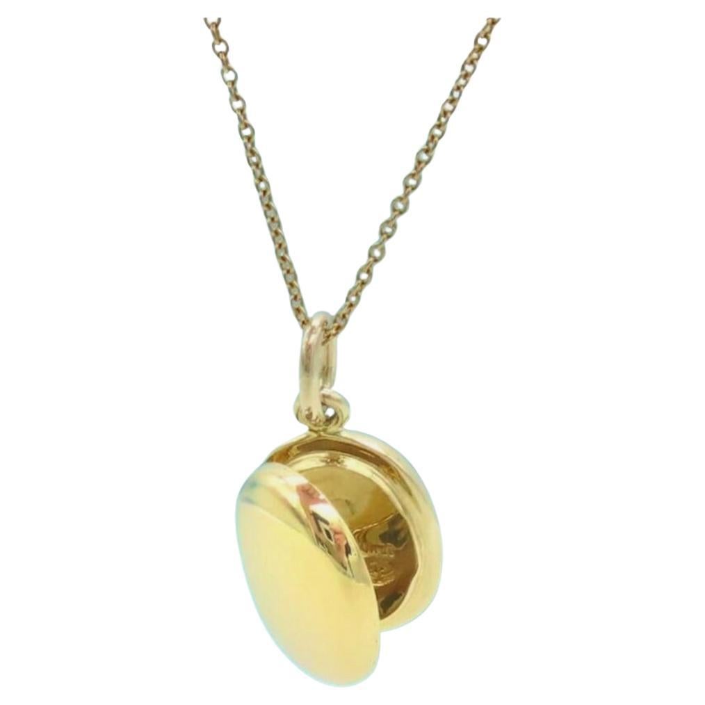 Like new unique Tiffany's 18 Karat gold locket on an 18 inch Tiffany's gold chain.  Beautiful craftsmanship.  You can put two small photos inside the locket, one on each side.  Perfect for a new Mom or Grandmother! 