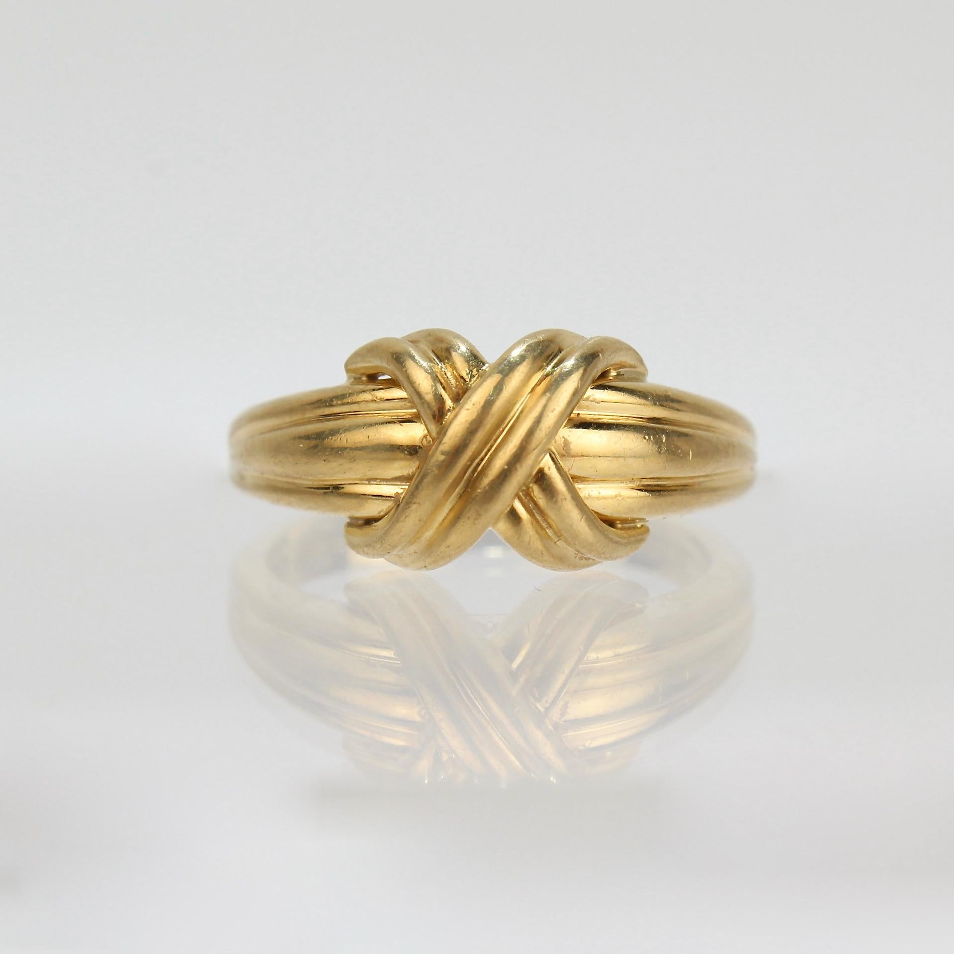 A very fine 'X' ring. 

By Tiffany & Co.

In 18k yellow gold.

Simply classic design by Tiffany & Co!

Date:
Late 20th Century

Overall Condition:
It is in overall good used estate condition with some fine & light surface scratches and other signs