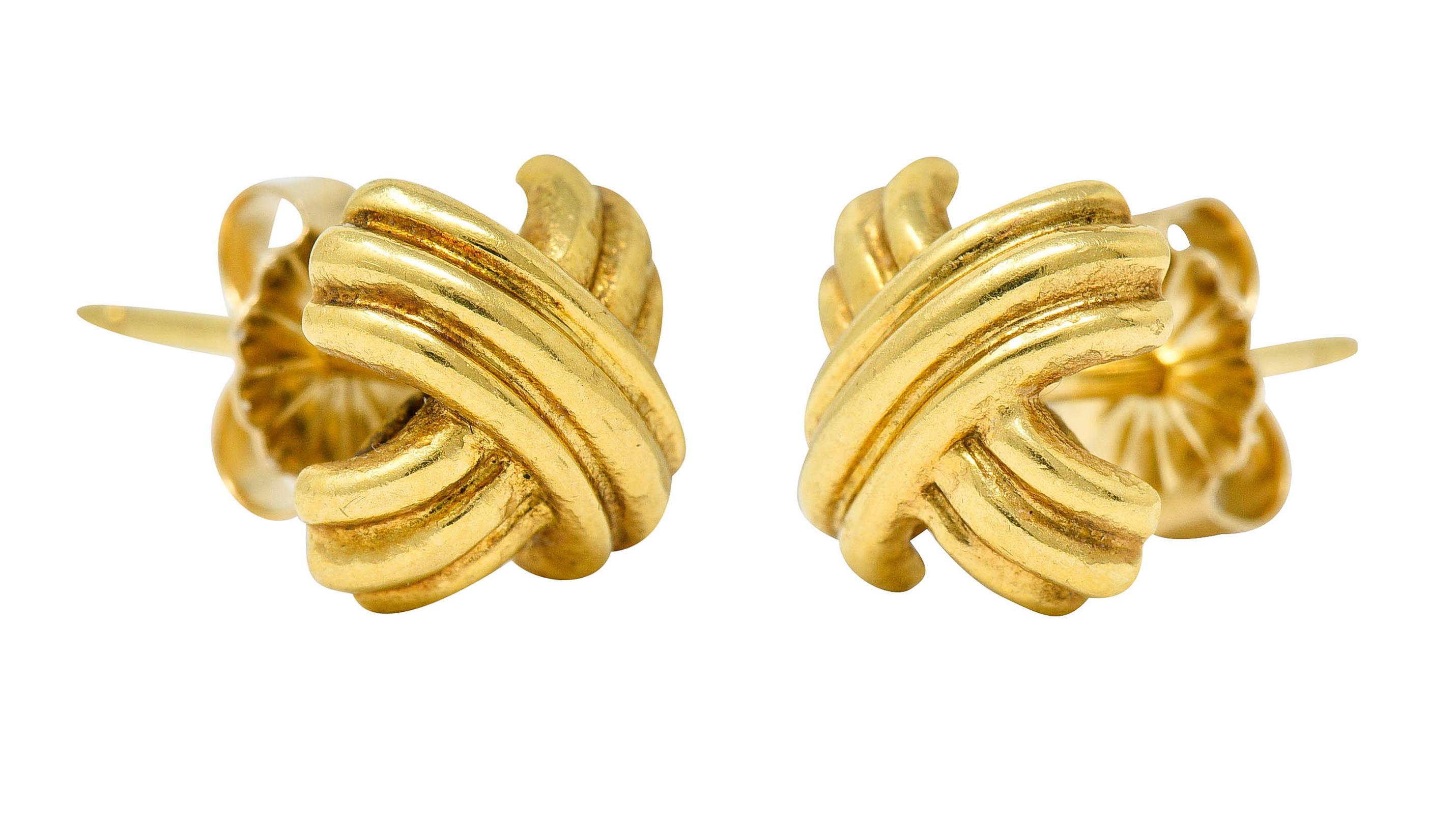 Stud earrings are designed as a deeply ridged X

With a brightly polished finish

Completed by posts and friction backs

Stamped 750 for 18 karat gold

Signed T & Co. for Tiffany & Co.

Circa: 1990s

Measures: 3/8 x 3/8 inch

Total weight: 3.2