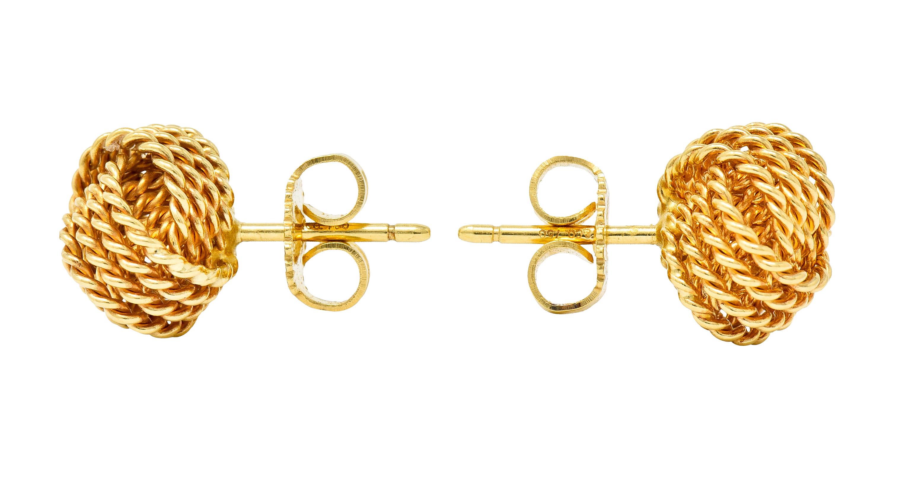 Stud style earrings designed as circles of gold comprised of a twisted rope motif

Intersecting to form the iconic monkey's fist sailor's knot

From the Tiffany Twist collection, circa 2000s

Completed by posts and friction backs

Posts are signed T