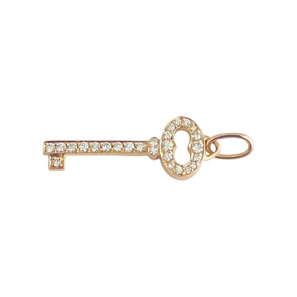 Tiffany & Co. 18k Rose Gold and Diamond Mini Key Pendant

Condition:  Excellent Condition, Professionally Cleaned and Polished
Metal:  18k Gold (Marked, and Professionally Tested)
Weight:  1.2g
Length:  1.1 Inches
Width:  .3 Inches
Diamonds:  Round