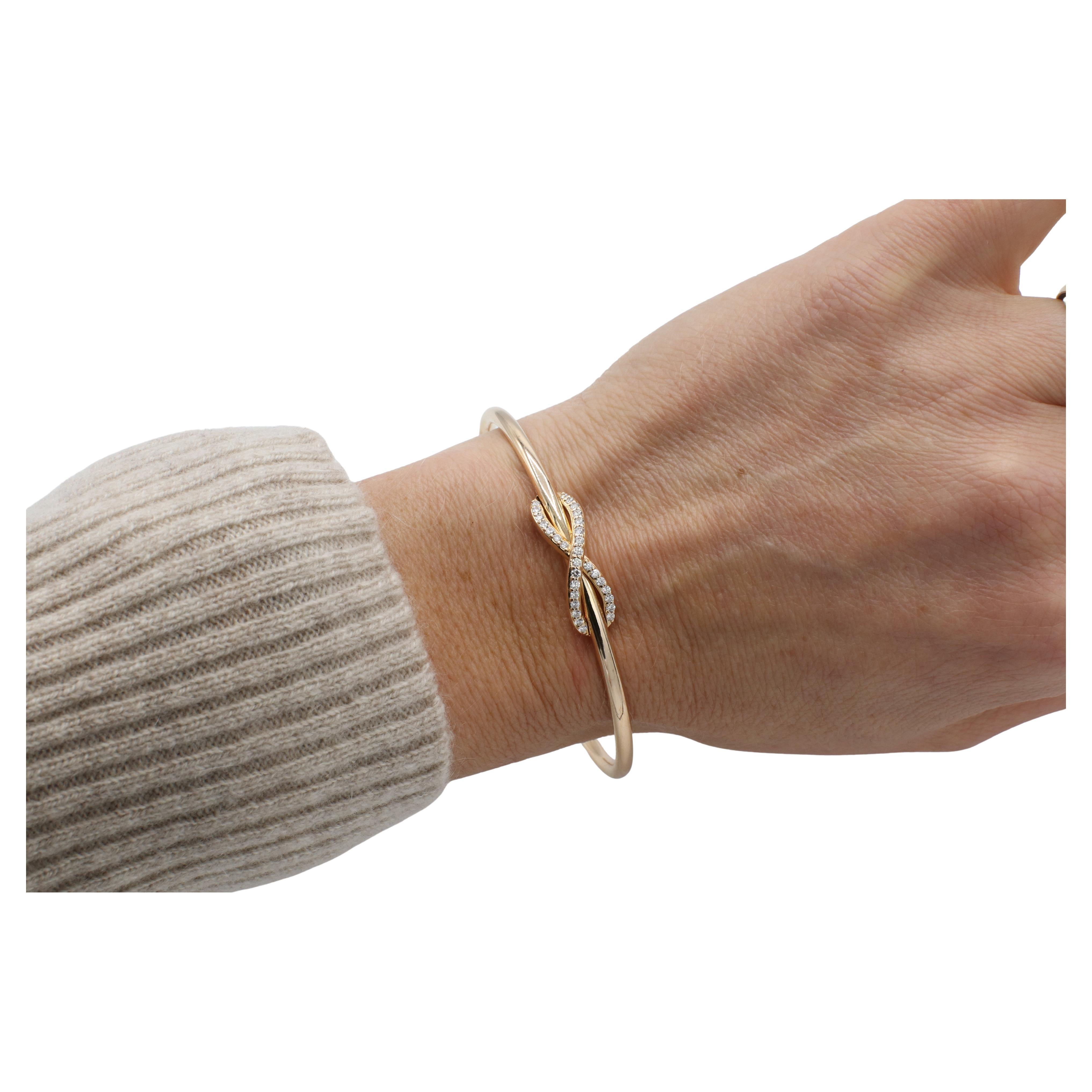 Tiffany & Co. 18 Karat Rose Gold Natural Diamond Infinity Cuff Bracelet 
Metal: 18k rose gold
Weight: 18 grams
Diamonds: Approx. 0.30 CTW D-F VVS round natural diamonds
Diameter: 2.50 inches
Size: Fits up to 6.75 inch wrist
Width: 3mm
Signed: ©T&Co.