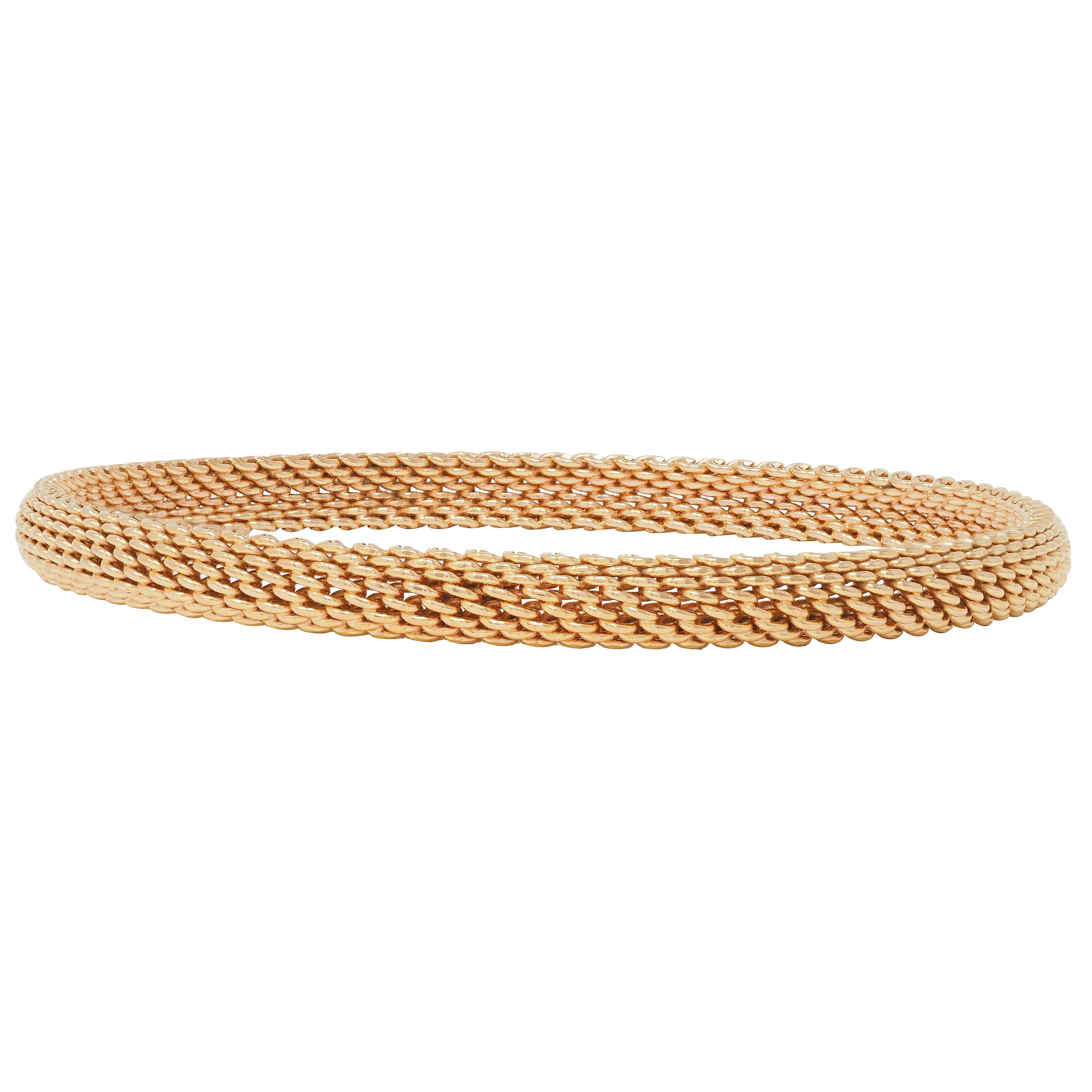 Designed as a curved bangle comprised of woven rose gold
Meshed with limited flexibility
Stamped for 18 karat gold
With maker's mark for Tiffany & Co. 
Circa: 2000s; via the Somerset collection
Width: 1/4 inch
Bracelet size: 7 1/2 inch circumference
