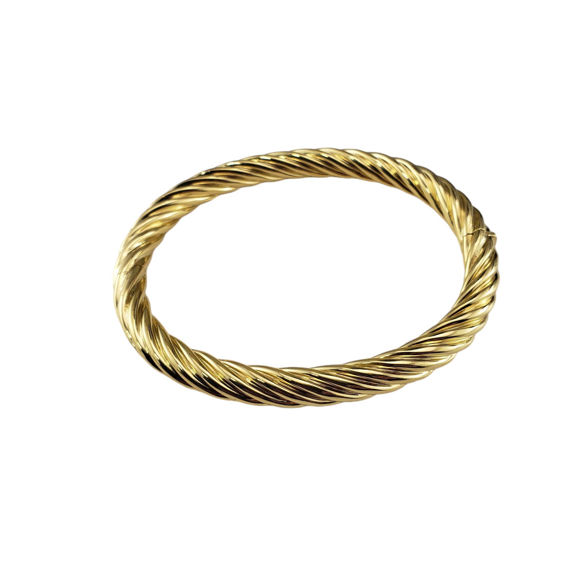 Tiffany & Co. 18K Twist Bangle Bracelet-

This elegant bracelet by Tiffany & Co. is crafted in meticulously detailed 18K yellow gold.  Hinged closure.
Width: 6.4 mm.

Hallmark:  ITALY  TIFFANY & CO. 750

Size: 7 inches

Weight:  14.4 dwt. /  22.4