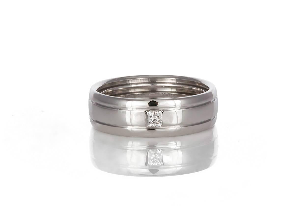We are pleased to offer this Authentic Tiffany & Co. 18k White Gold & Diamond Mens Wedding Band. It features a 0.10ct F-G/VS Radiant Cut Diamond set in 18k White Gold. It is a size 8 US and measures 7mm wide. The ring is in very good condition with