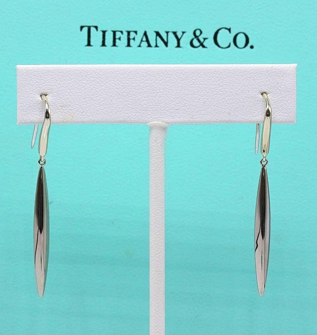 Tiffany & Co.
Style:  Feather Hook dangle Earrings
Length:  1.75 inches
Metal:  18KT White Gold
Hallmark:  ©T&Co.750
Includes:  Tiffany & Co. jewelry pouch