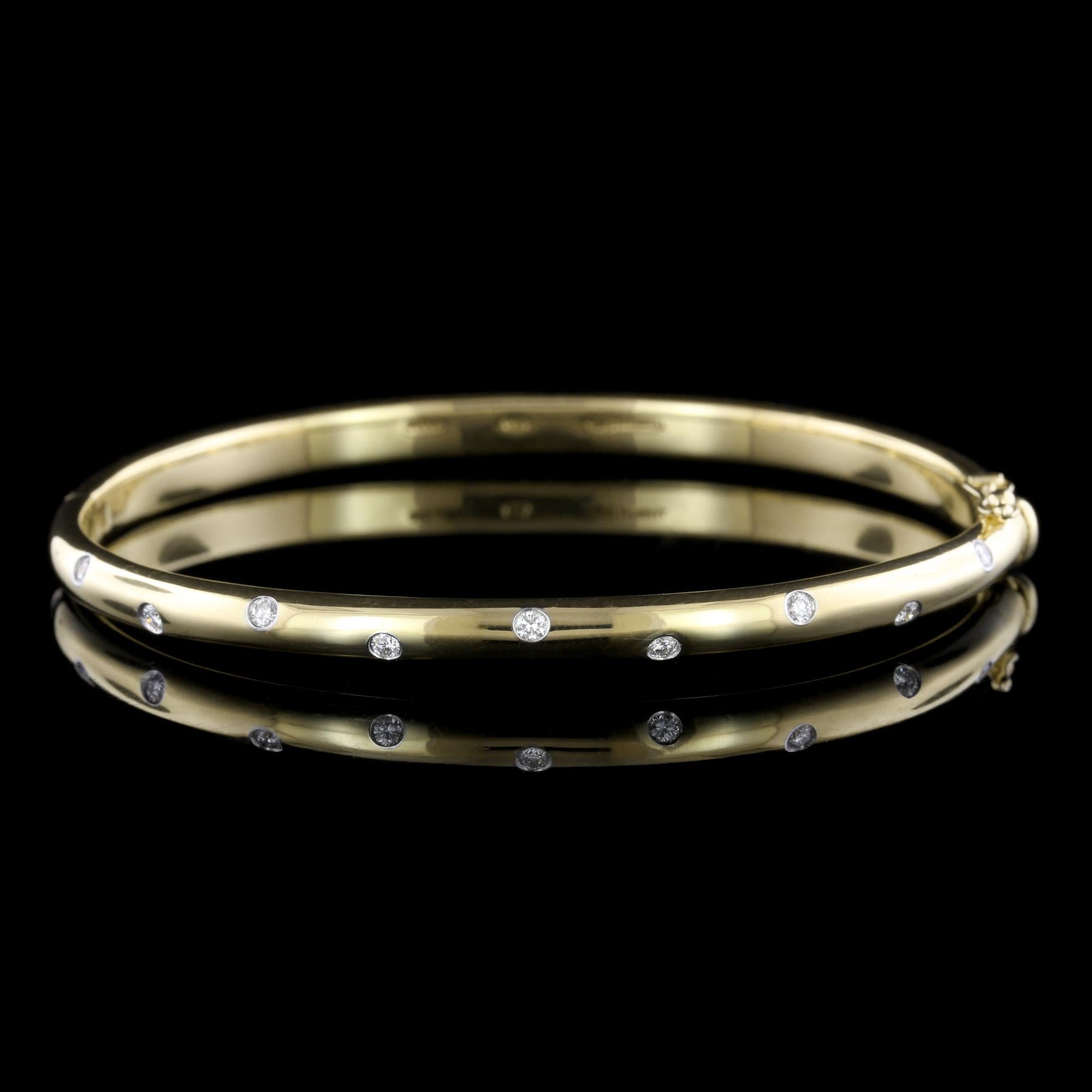 Tiffany & Co. 18K Yellow Gold and Platinum Diamond Etoile Bangle. The hinged bangle is set with ten full cut diamonds, approx. total wt. .22cts.