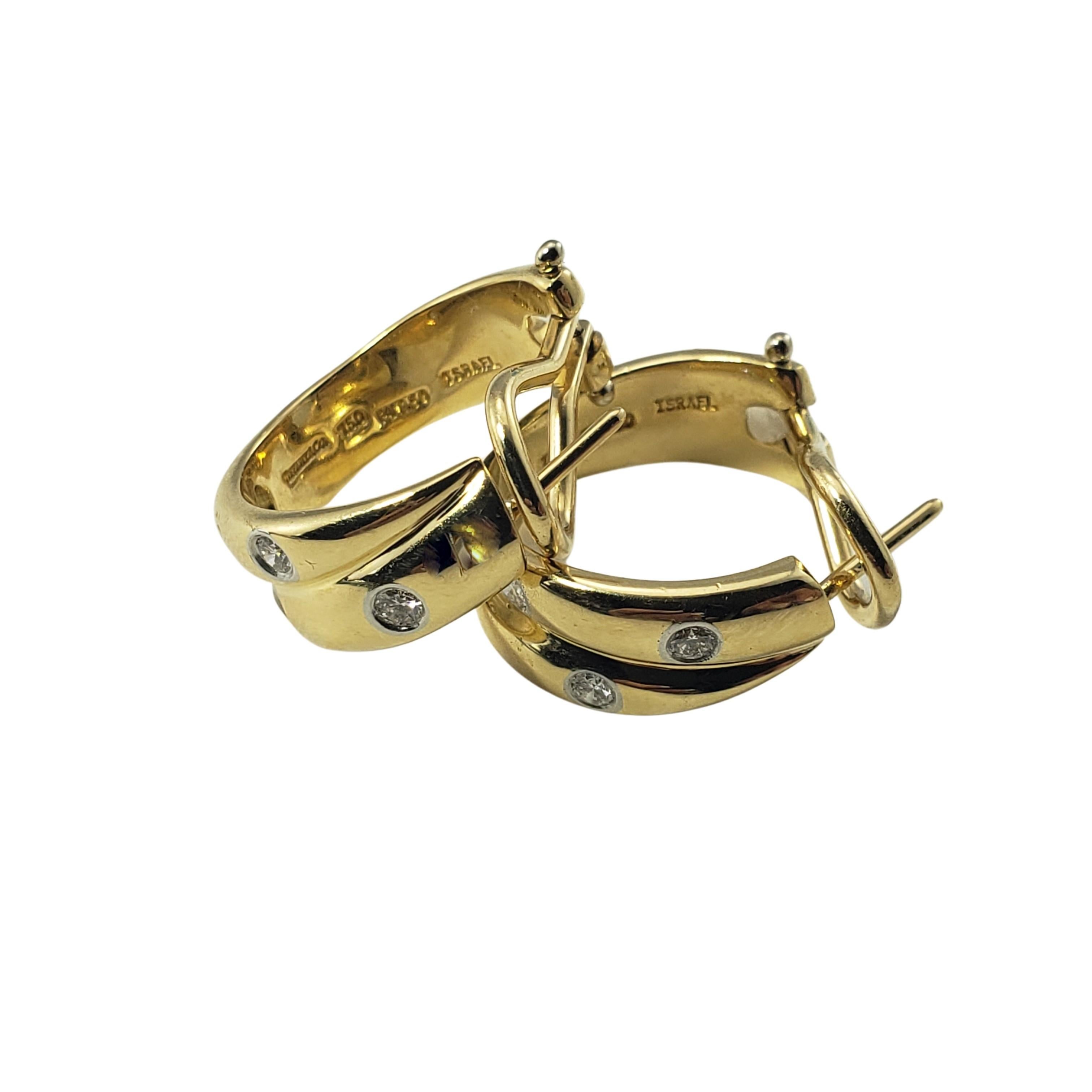 Tiffany & Co. 18 Karat Yellow Gold and Platinum Etoile Hoop Earrings-

These stunning double band hoop earrings each feature four round brilliant cut diamonds set in classic platinum and 18K yellow gold.  Omega back closures.  Width:  7