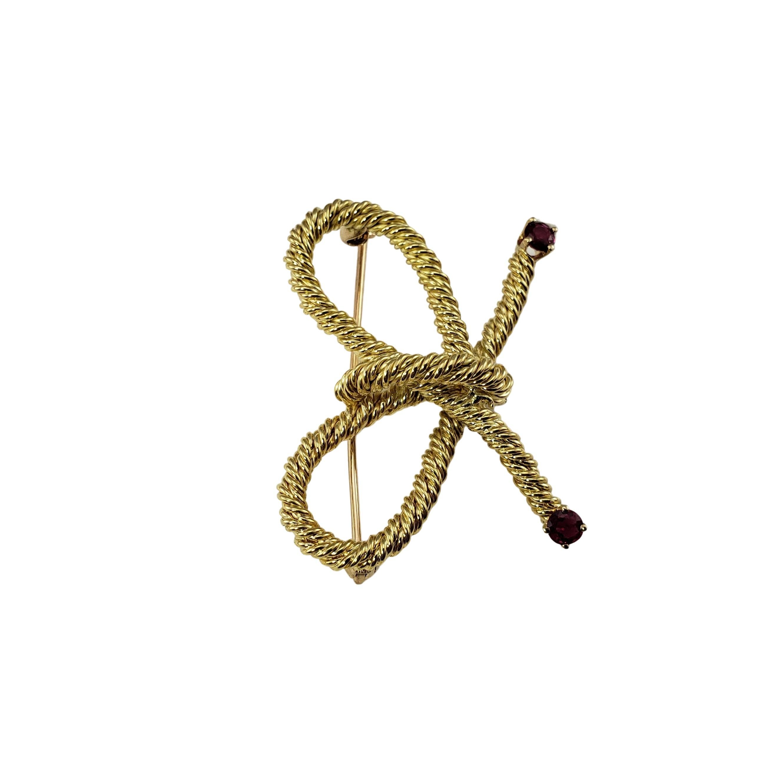 Tiffany & Co 18 Karat Yellow Gold and Ruby Brooch/Pin-

This elegant Tiffany pin is crafted in beautifully detailed 18K yellow gold and accented with two ruby gemstones.

Size:  25 mm x  35 mm

Weight:  6.1 dwt. / 9.5 gr.

Hallmark:  18K  Tiffany &