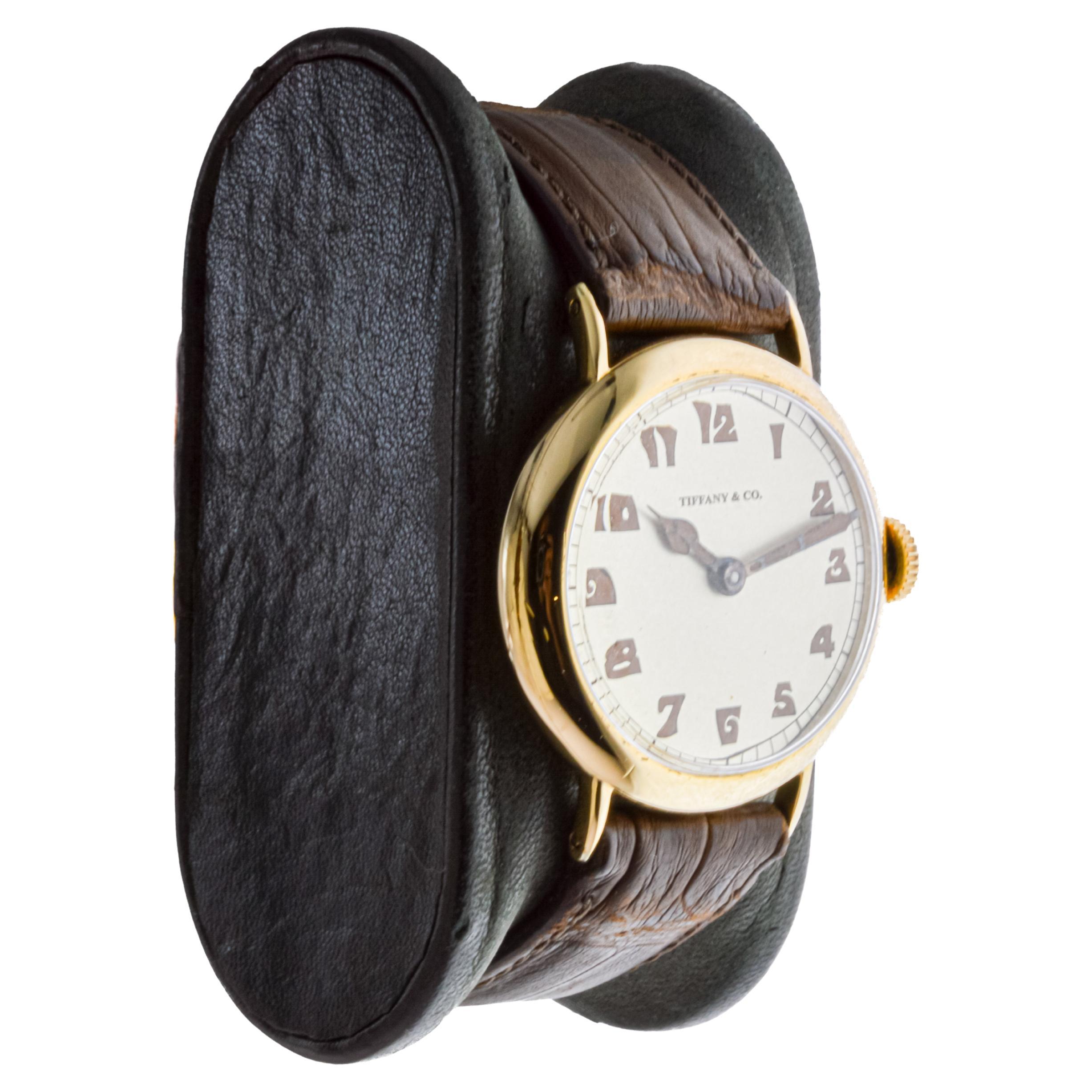 FACTORY / HOUSE: International Watch Company / Tiffany & Co.
STYLE / REFERENCE: Campaign Style 
METAL / MATERIAL: 18Kt. Yellow Gold 
CIRCA / YEAR: 1920's
DIMENSIONS / SIZE: Length 38mm X Diameter 31mm
MOVEMENT / CALIBER: Manual Winding / 17 Jewels