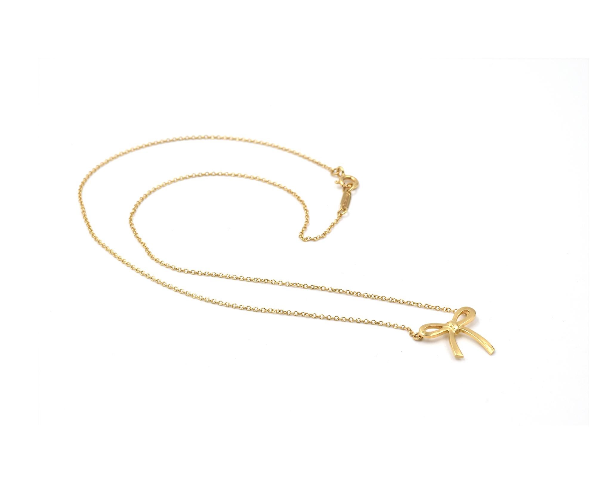 Designer: Tiffany & Co
Hallmarks: T & CO
Material: 18k yellow gold
Dimensions: necklace is 17-inch long, pendant is 1/2-inch long and 1/2-inch wide
Weight: 2.52 grams
Retail: $975
