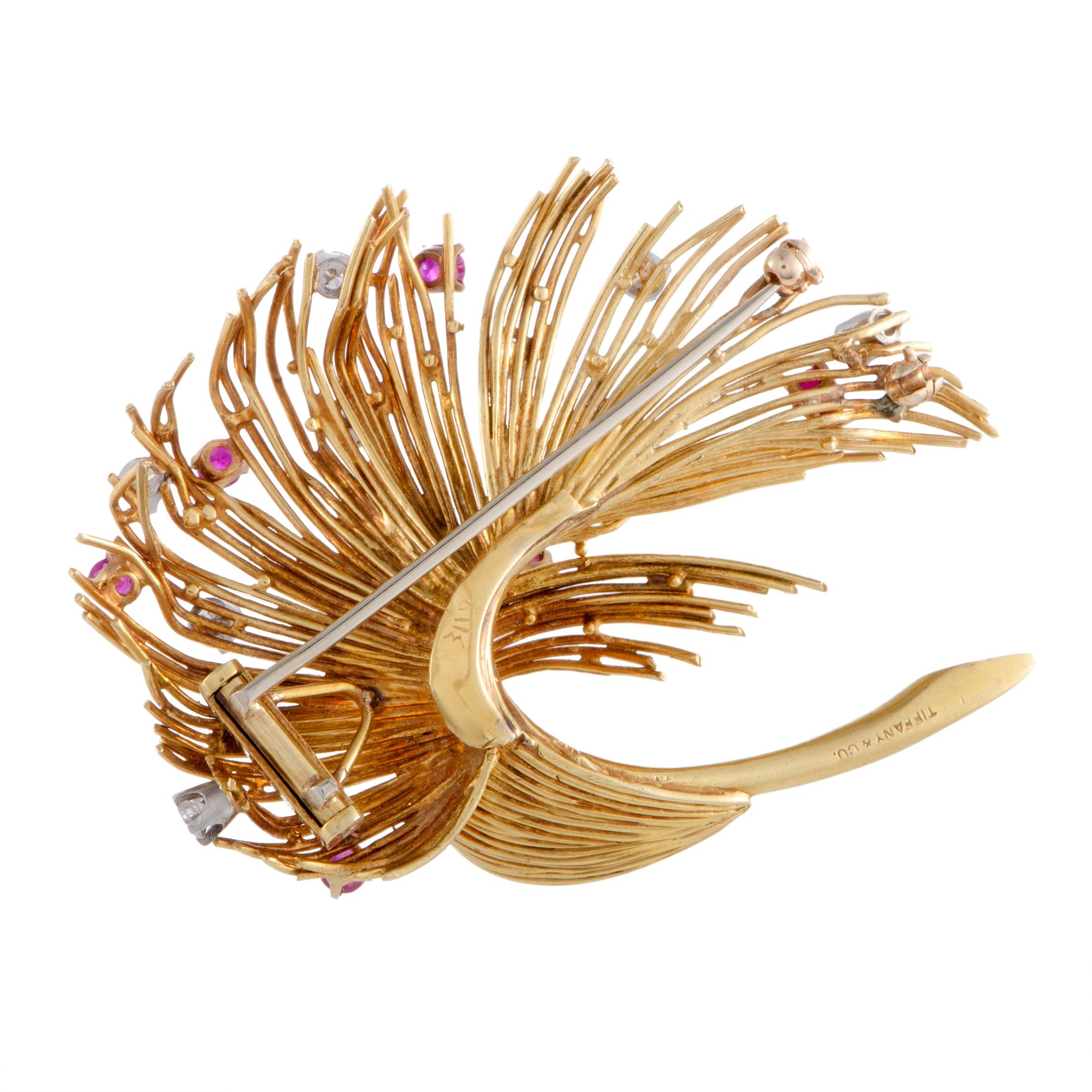 With its incredibly fashionable design that is beautifully topped off with dazzling diamonds and striking rubies, this extraordinary brooch from Tiffany & Co. will attractively accentuate any ensemble of yours. The brooch is made of radiant 18K