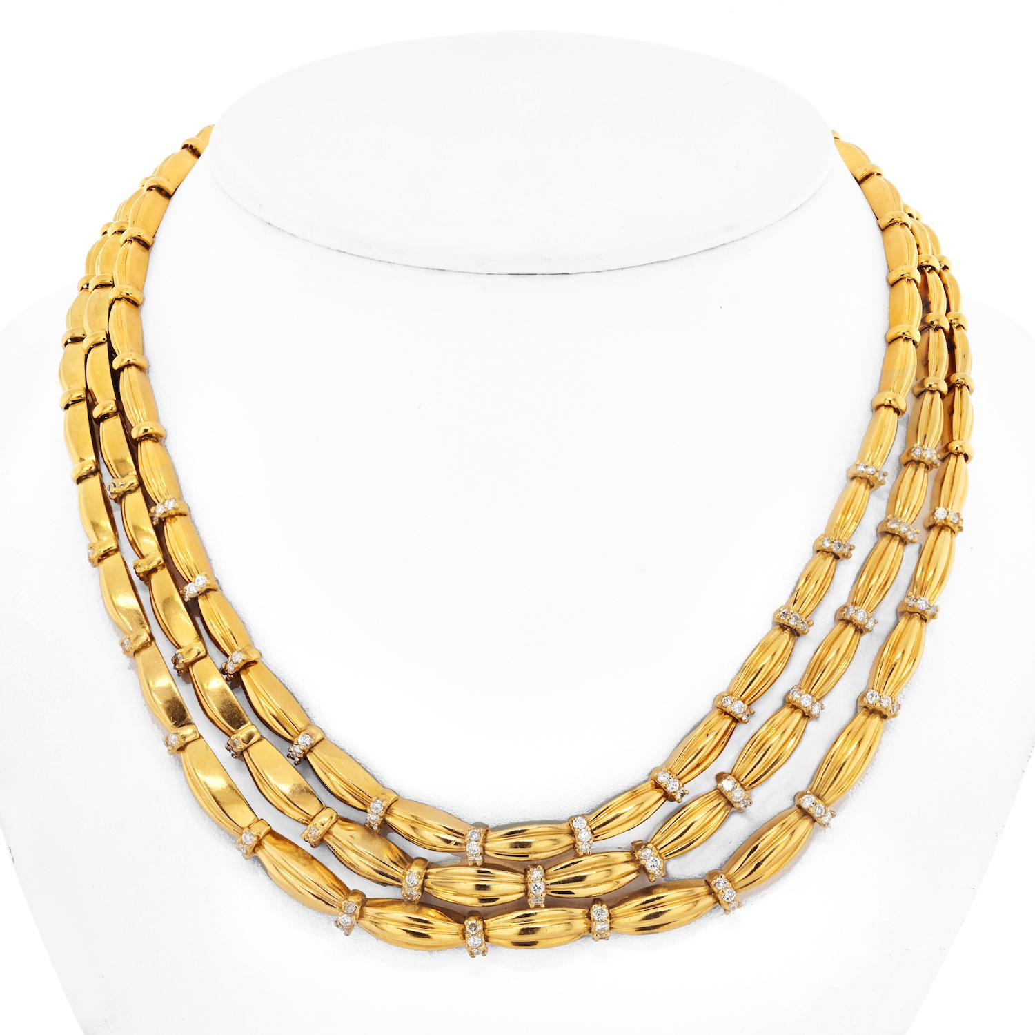 The 18k yellow gold vintage three strand Tiffany & Co necklace is a stunning piece of jewelry that exudes elegance and class. The necklace is designed as three strands of graduated fluted links, each link measuring approximately 10mm in size. The