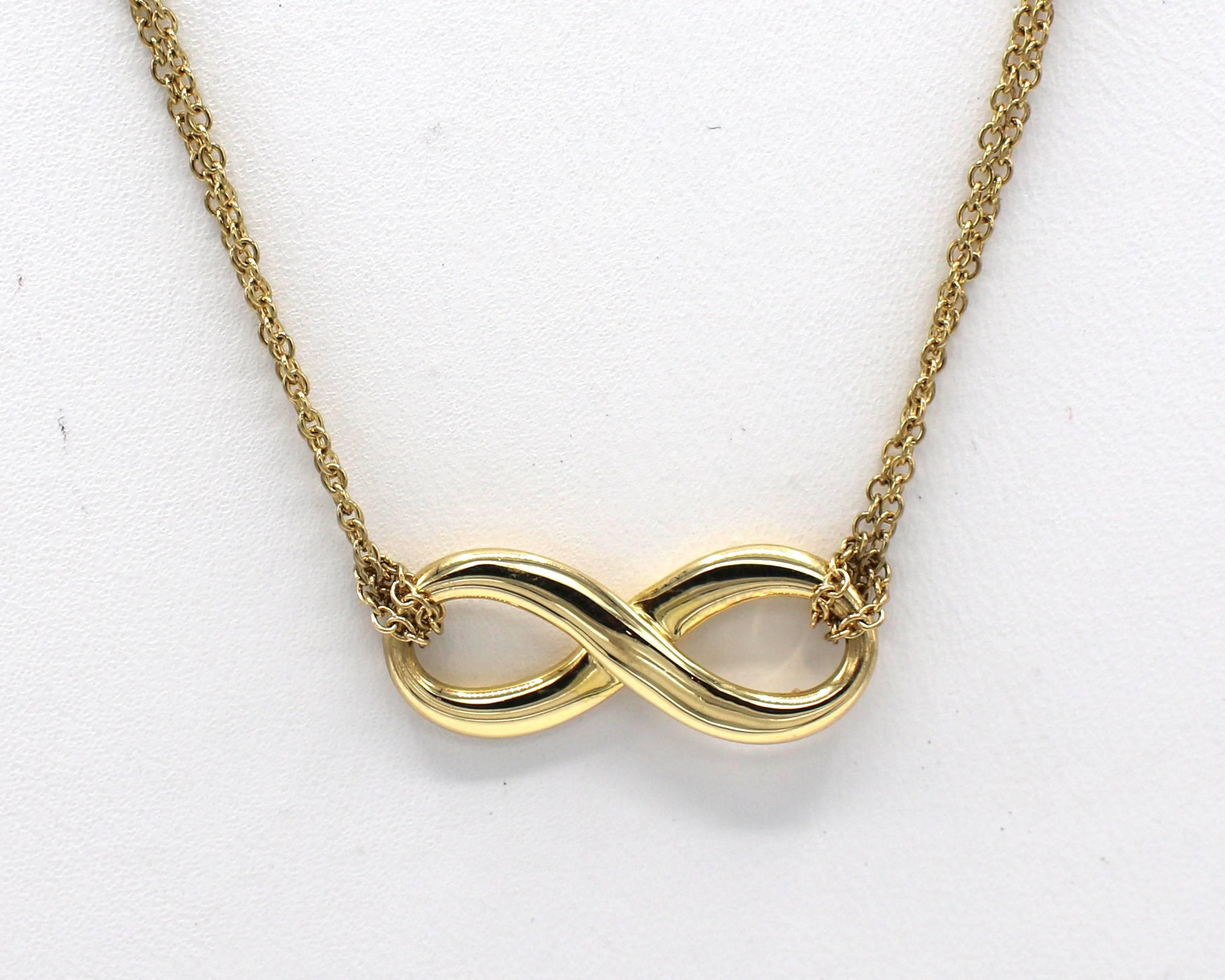 Tiffany & Co. 18 Karat Yellow Gold Double Chain Infinity Pendant Necklace 
Metal: 18 karat yellow gold
Weight: 4.41 grams
Length: 16 inches
Pendant: 20 x 8.5mm
