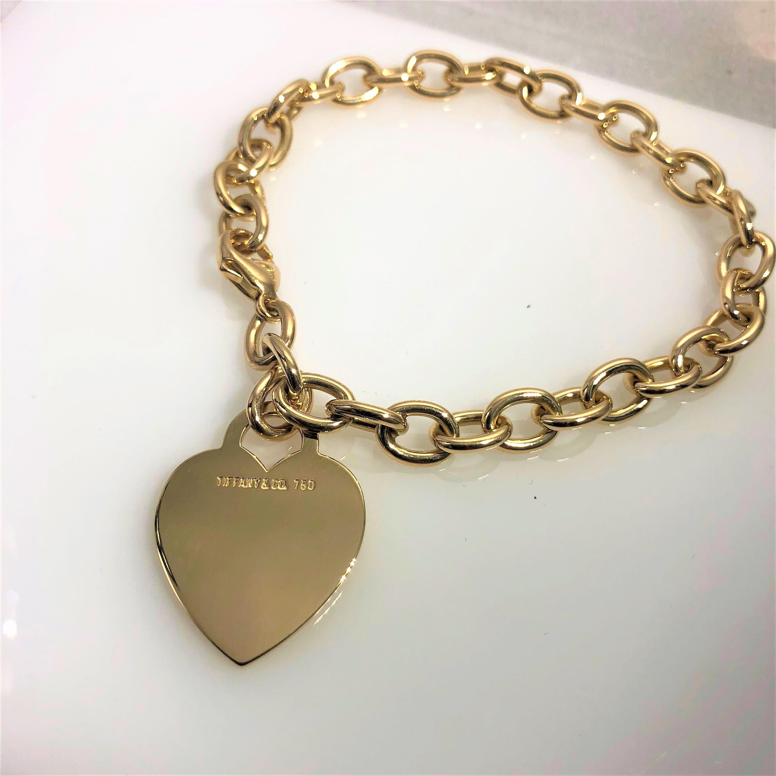 Tiffany&Co 18 Karat Heart Tag Charm Bracelet. This piece is a forever classic. Created in 18 karat yellow gold, stamped 750, this piece weighs 28.8 grams/ 18.5 dwt. Charm bracelet/ chain link design, with tag style heart charm stamped with logo