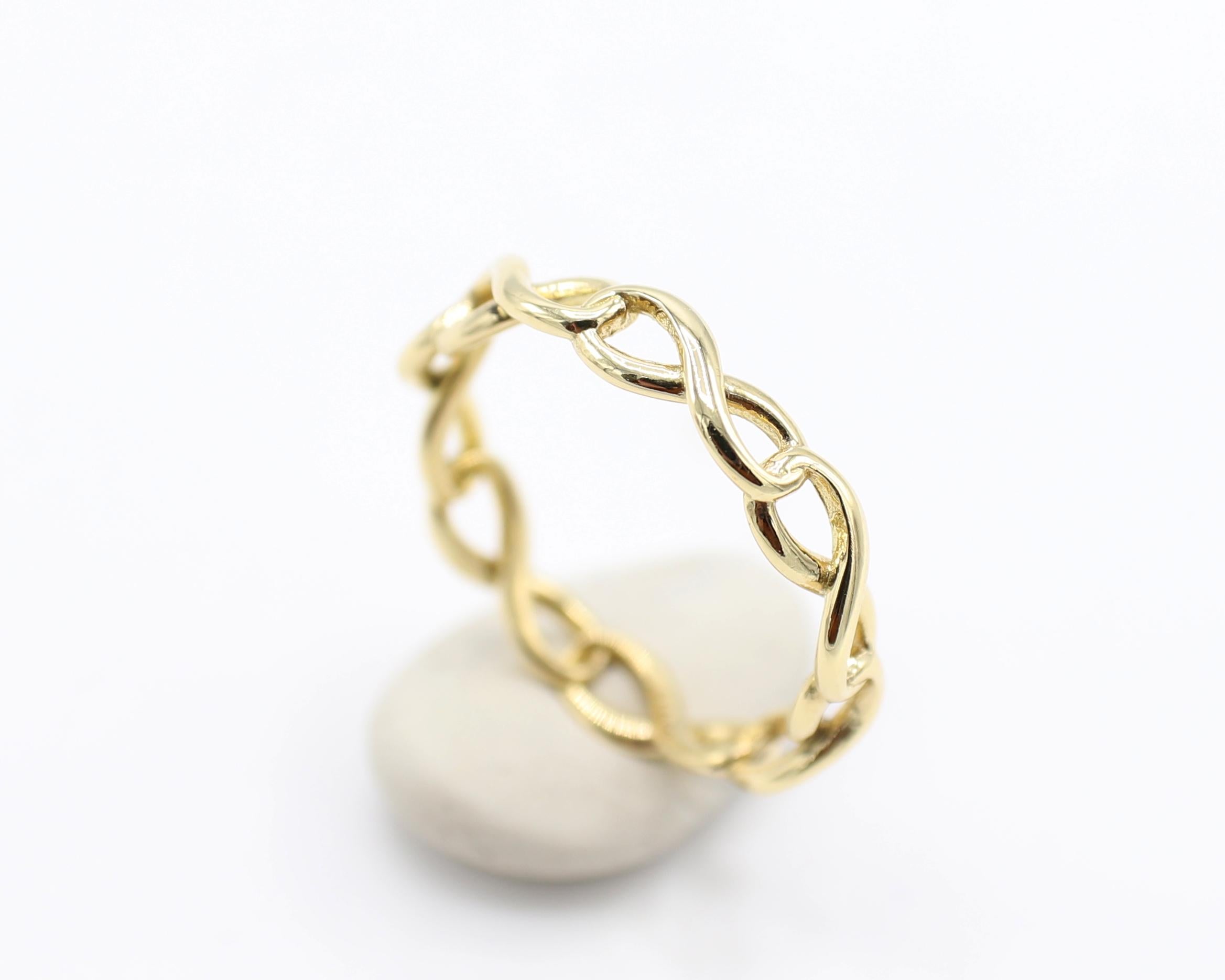 Tiffany & Co. 18 Karat Yellow Gold Infinity Narrow Band Ring 
Metal: 18k yellow gold
Weight: 2.01 grams
Size: 6 (US)
Width: 3.4mm
Signed: T&Co. Au750
