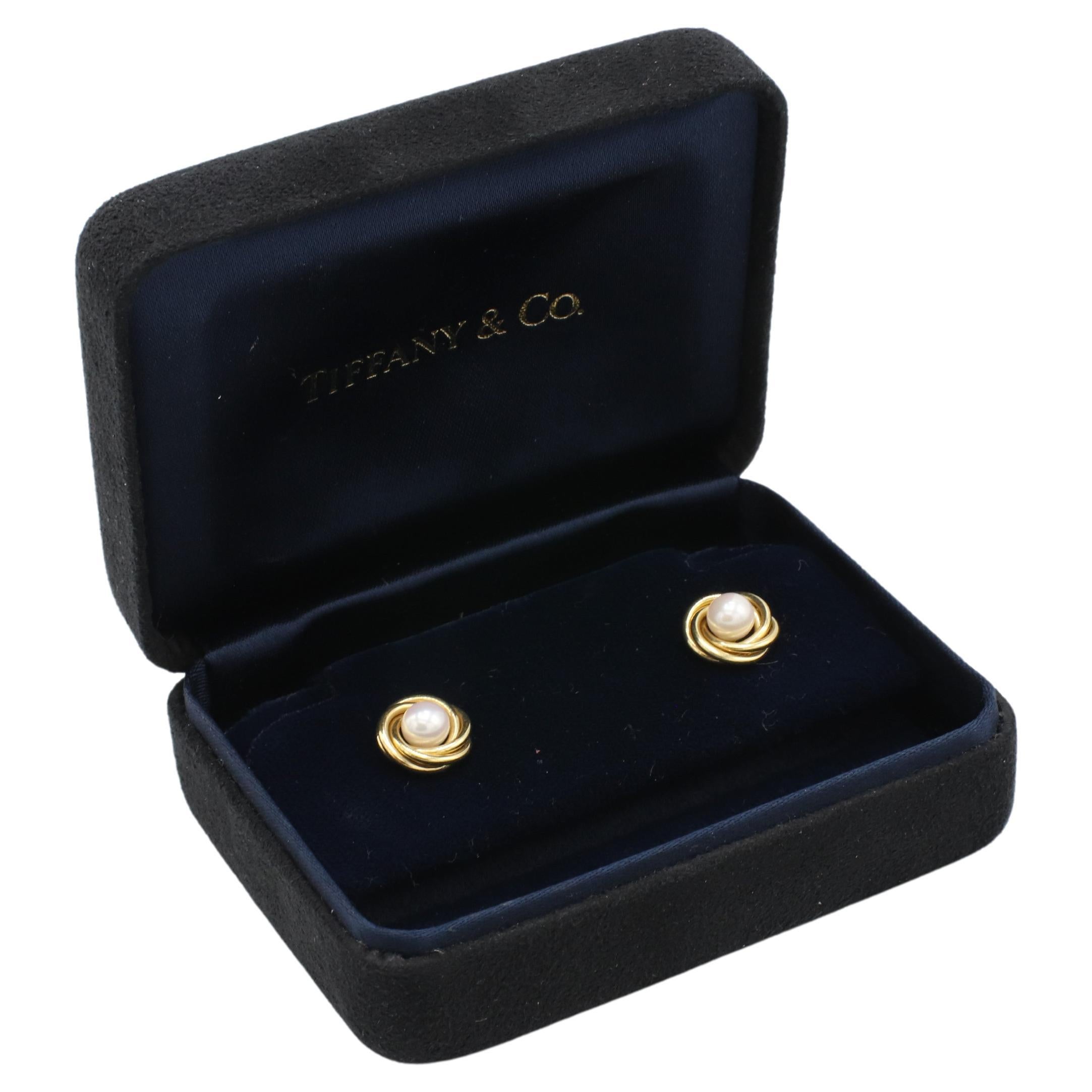 Tiffany & Co. 18 Karat Yellow Gold Knot Pearl Stud Earrings 
Metal: 18k yellow gold (backs 14k)
Weight: 4.34 grams
Diameter: 10.5mm
Pearls: 5mm, white Akoya cultured pearls
Backs: Push backs, (backings not T&Co.)