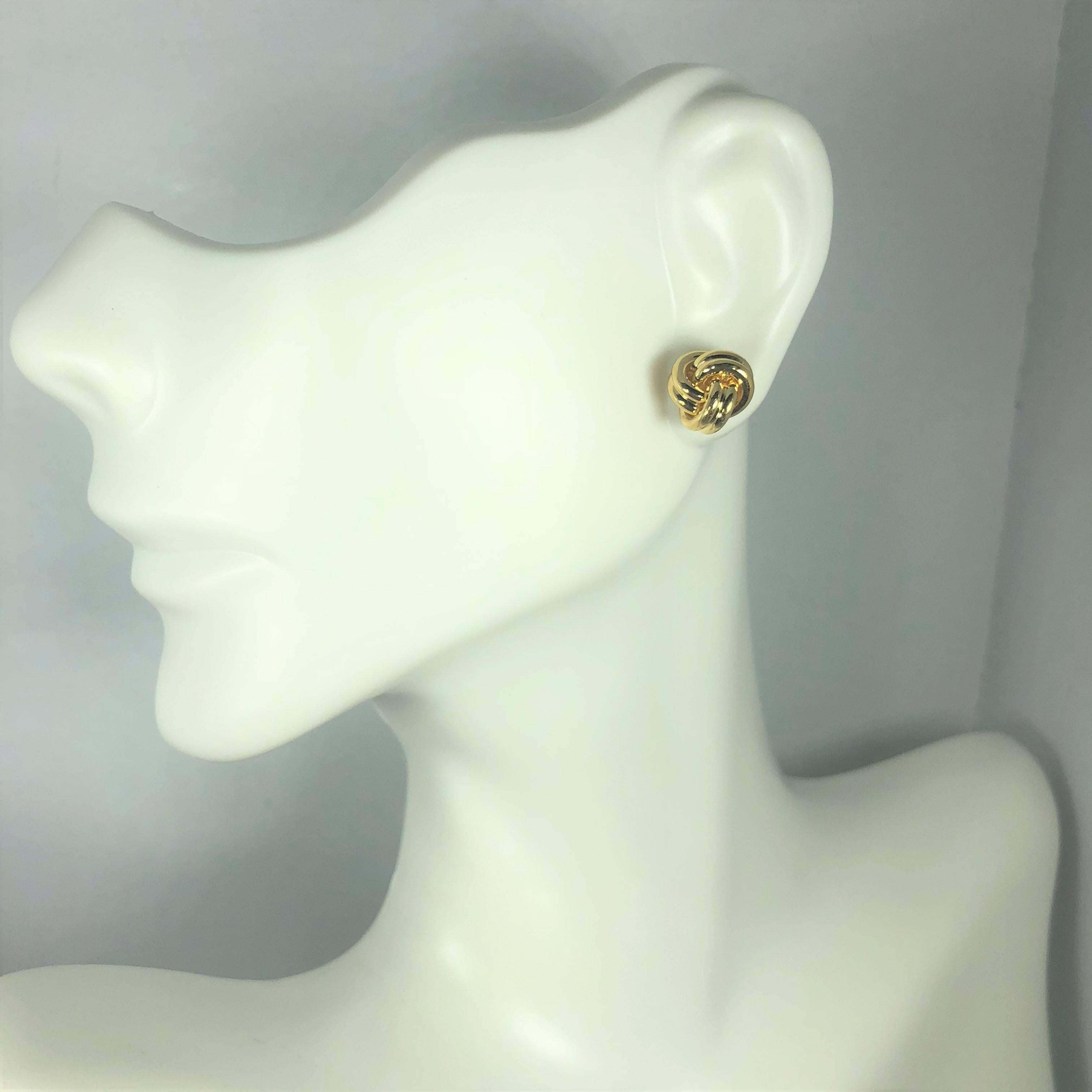 Tiffany & Co. 18 karat yellow gold love knot stud earrings. These classic Tiffany & Co earrings are created in 18 karat yellow gold and weigh 5.4 grams. They are a 3 dimensional knot design, stud earring. Measuring approx. 9mm. Signed on posts