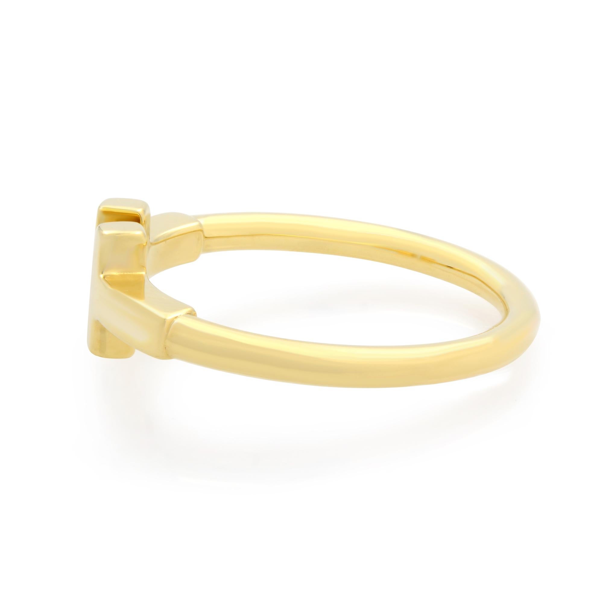 Tiffany & Co 18k yellow gold Tiffany T wire ring. Size 5. As multifaceted as it is iconic, the Tiffany T collection is a tangible reminder of the connections we feel but can't always see. Style this ring with other Tiffany rings for a striking