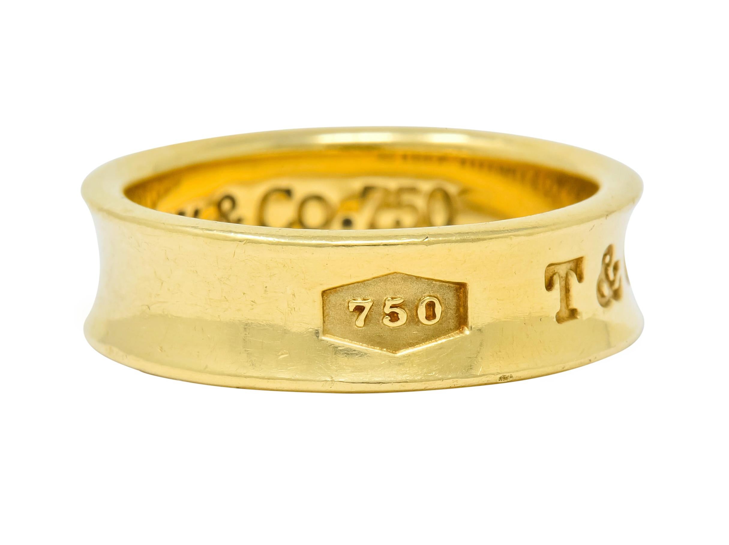 High polished gold band with recessed central groove

Deeply engraved to front 750, T & Co., and 1837

From the celebratory Tiffany 1837 Collection

Inner shank fully signed Tiffany & Co. 1997

Stamped 750 for 18 karat gold

Ring Size: 6 1/2 & not