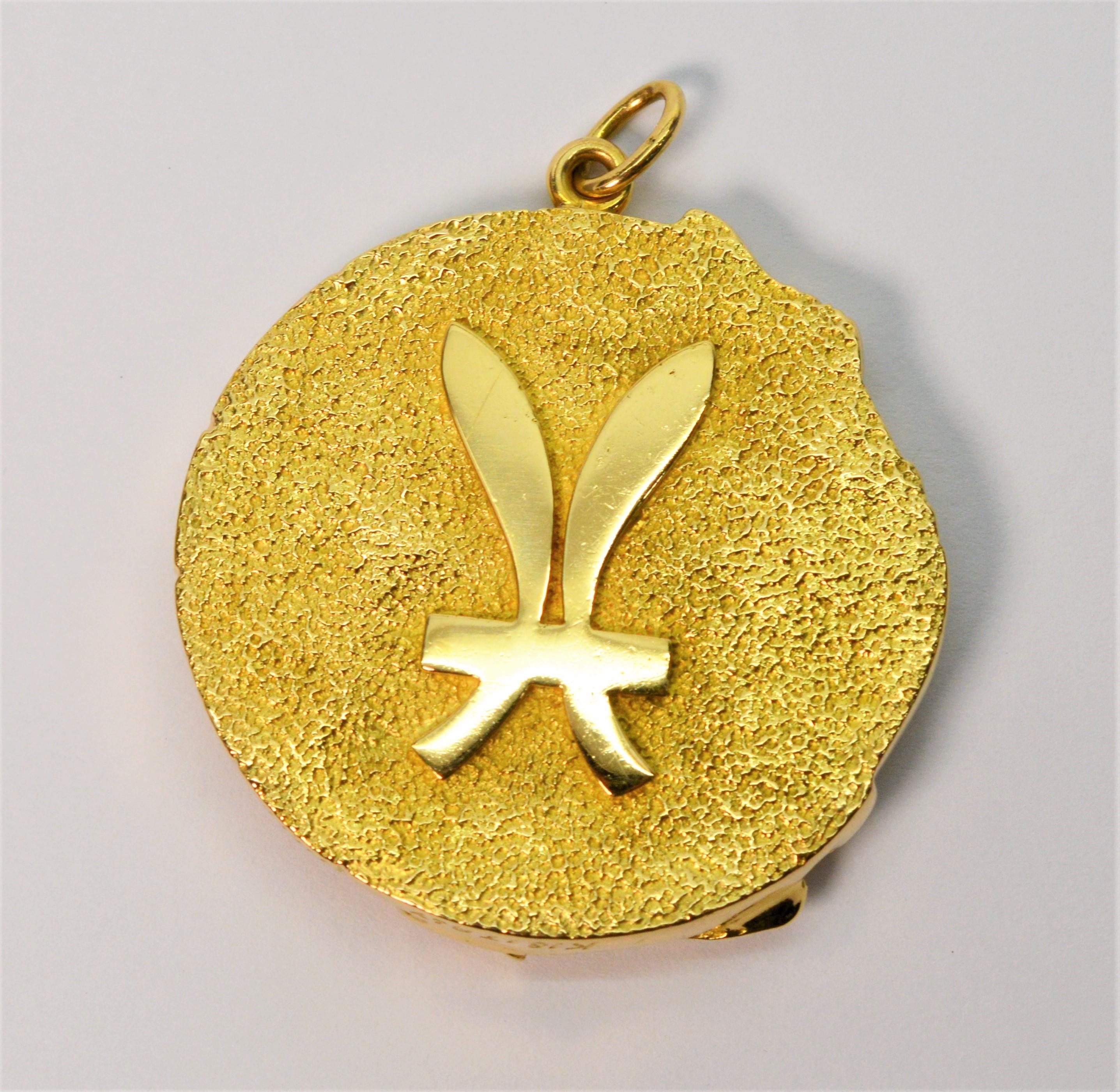 Tiffany & Co.'s  signature zodiac pendant, circa 1970's, makes a bold gold statement. In the astrological sign of Pisces, the front depicts a pair of fish in a raised relief with a matte on bright finish. The reverse has the Pisces symbol. The