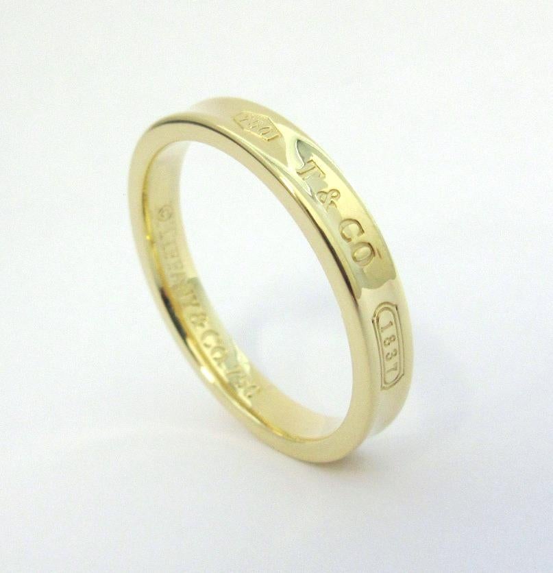 TIFFANY & Co. 1837 18K Gold 4mm Band Ring 13 Men's

Metal: 18K yellow gold 
Size: 13
Band Width: 4mm
Weight: 7.90 grams
Hallmark: 