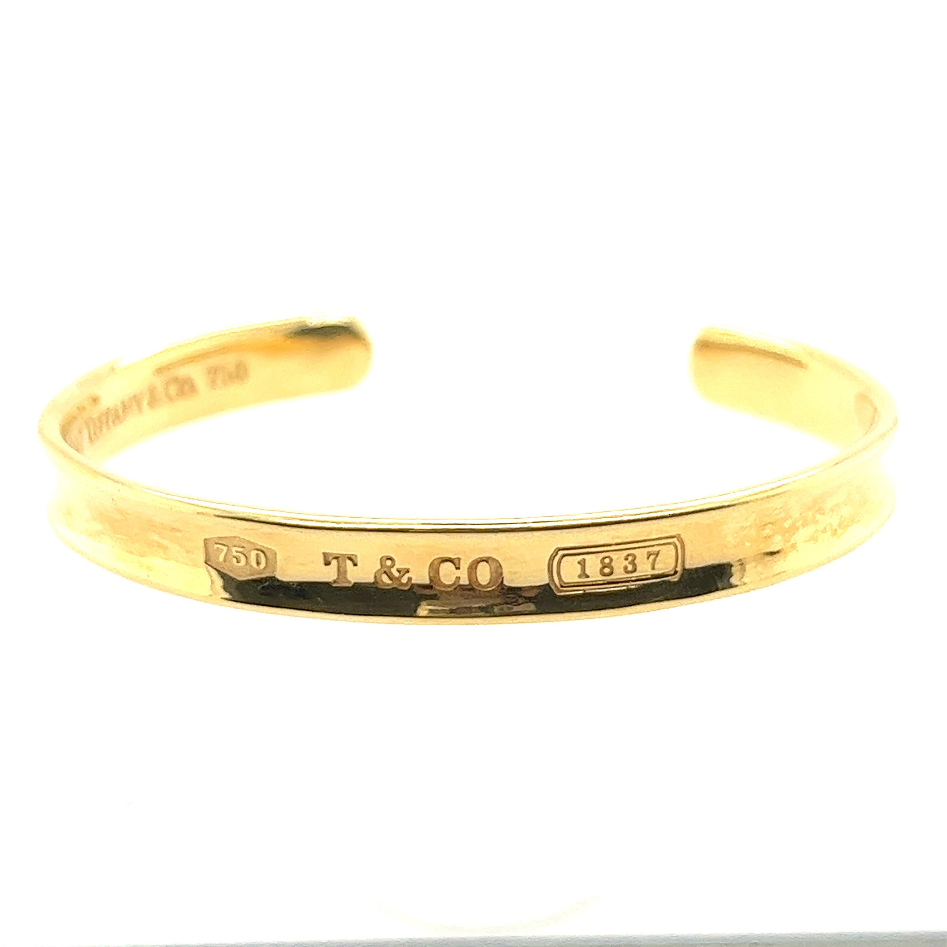 Crafted in 1997, this beautiful Tiffany & co cuff is made of 18k yellow gold. It is engraved with T & Co, 1837 and 750 which stands for 18k gold. It has hallmark on inside of the bracelet. 