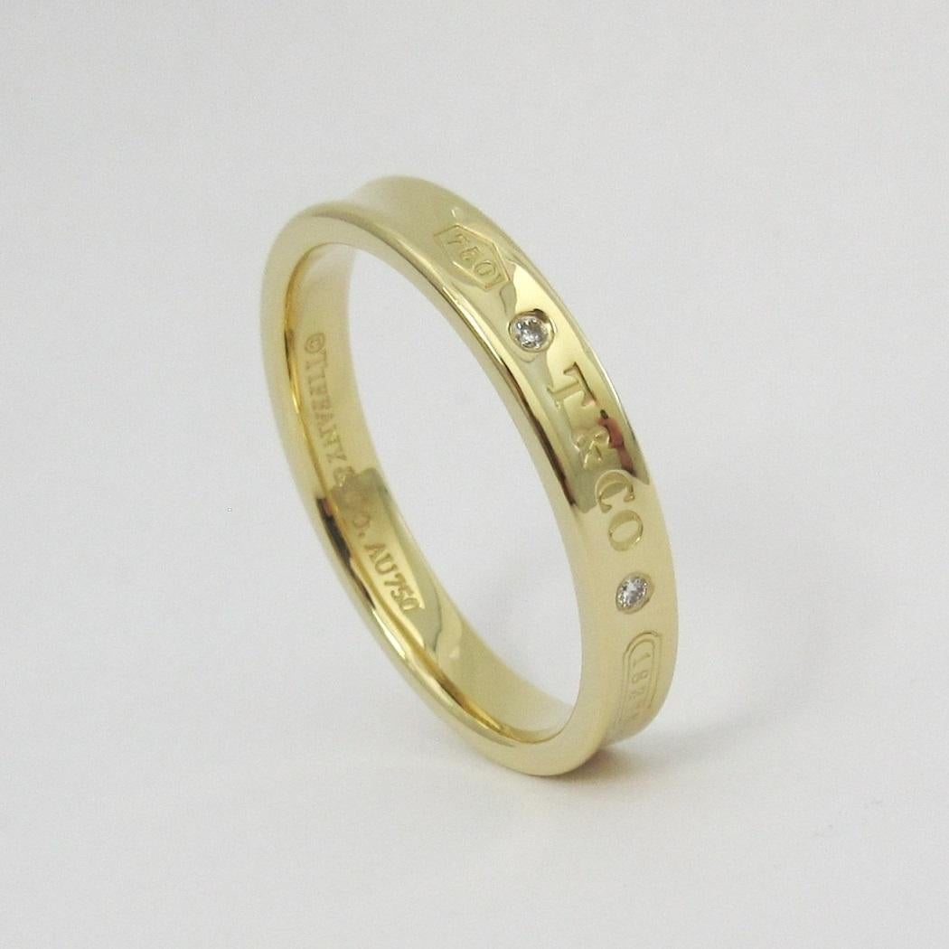 TIFFANY & Co. 1837 18K Gold Diamond 4mm Band Ring 12.5 Men's

Metal: 18K Gold
Size: 12.5 
Band Width: 4mm
Weight: 7.50 grams
Diamond: 2 round brilliant diamonds, carat total weight .04
Hallmark: 