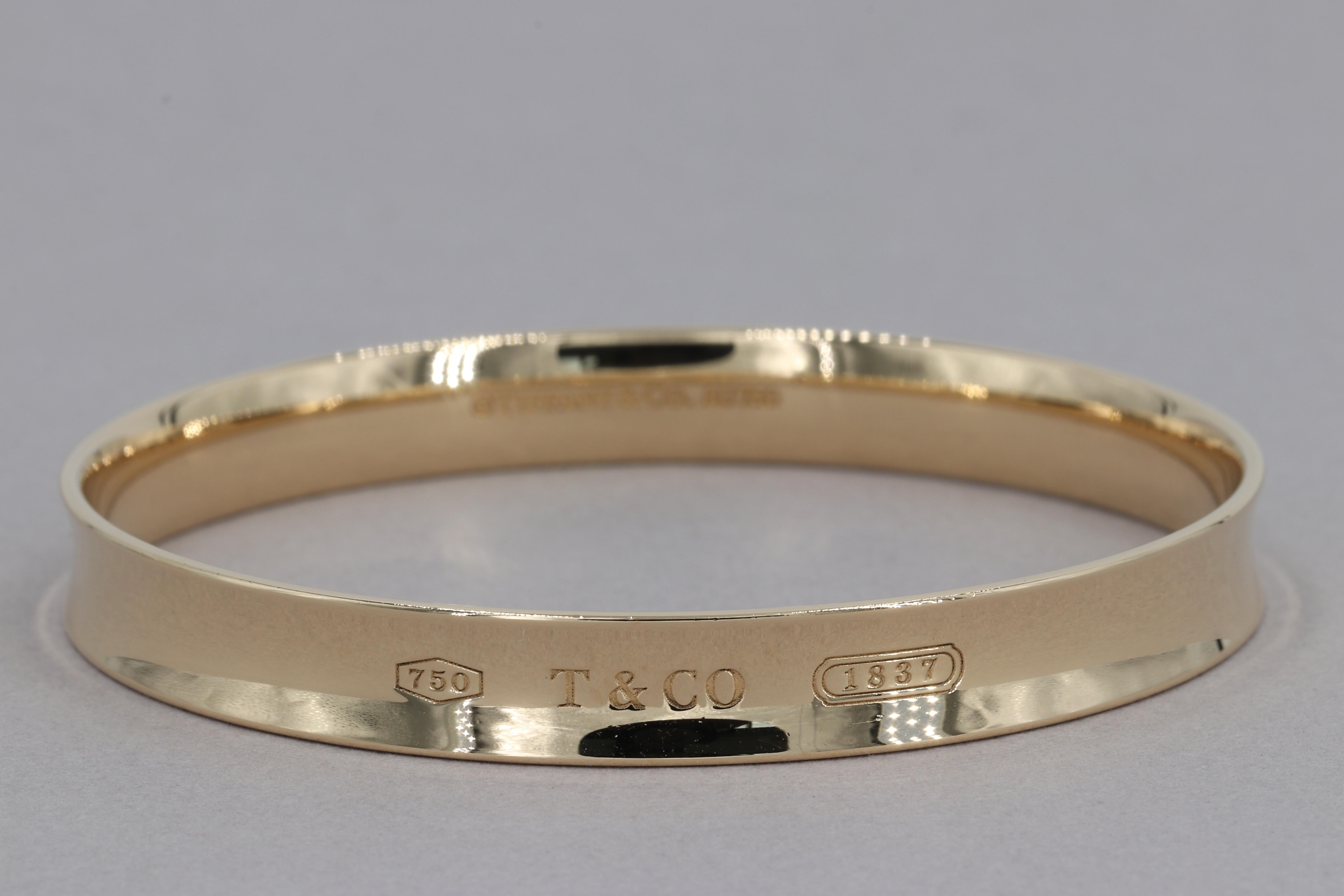 Tiffany & Co. 1837 Bangle Bracelet 8mm 18 Karat Yellow Gold 

Weight - Approximately 29.8 grams

Width - Approximately 8 mm

Height - Approximately 2.10 mm

Diameter - Approximately 2.5 inches - Translates to Approximately 7.85