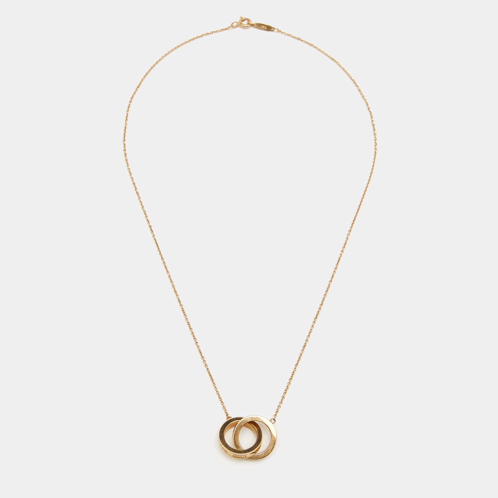 The Tiffany & Co. 1837 necklace is a symbol of timeless elegance. Crafted with exquisite attention to detail, the interlocking circles design represents eternal unity and connection. Made from luxurious 18k yellow gold, this necklace is a stunning