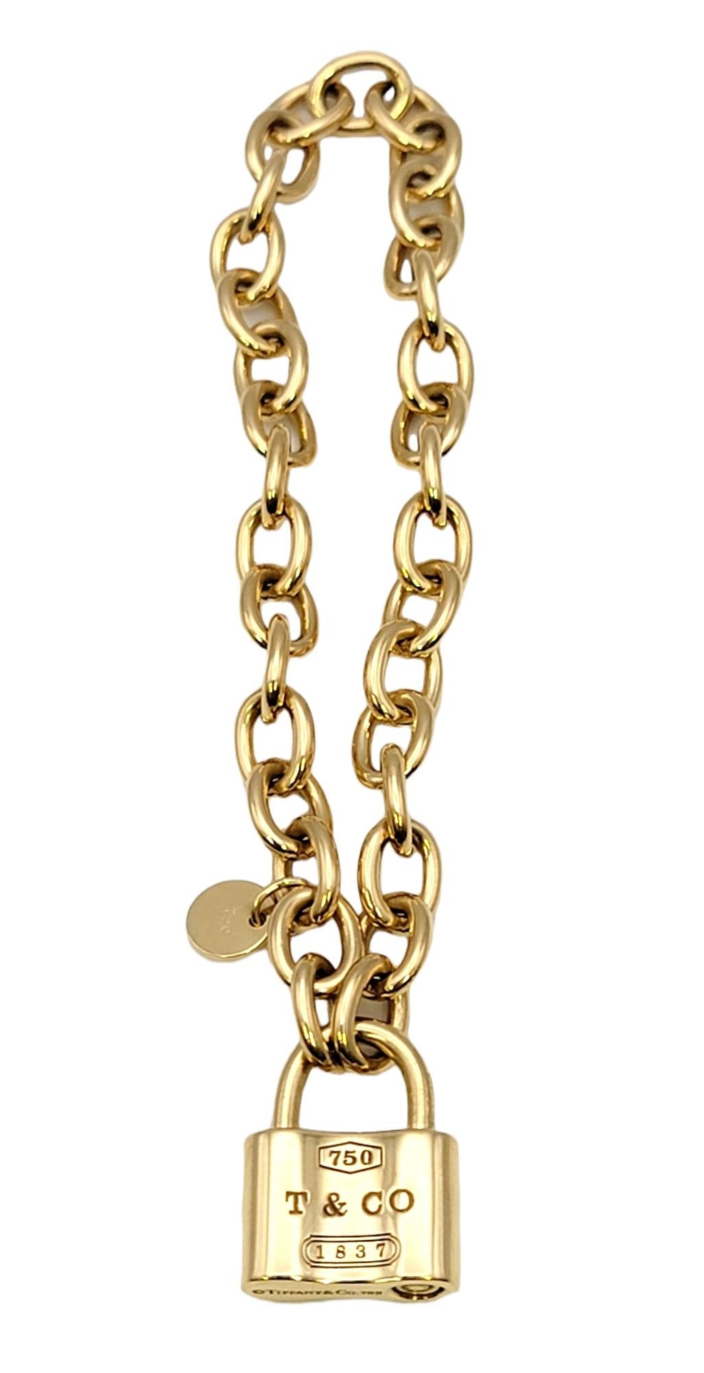 You will love this classic chain bracelet by Tiffany & Co.. It features a working square padlock at the center engraved with '750 T&CO 1837'. This polished 18 karat yellow gold designer beauty is simple yet stunning and can be worn with just about